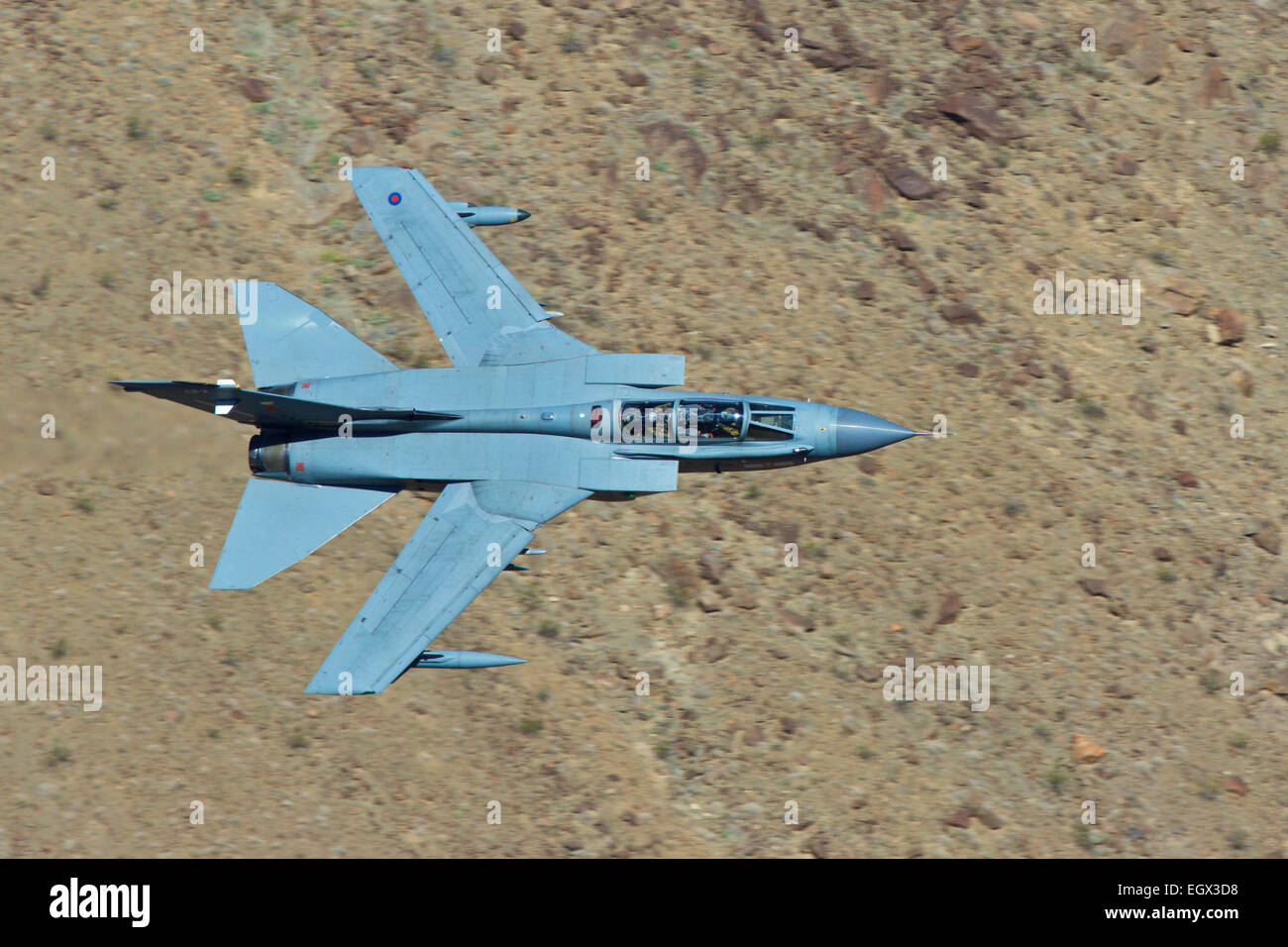 Royal Air Force Tornado GR4 Flying At Low Level Through A Desert Valley. Stock Photo