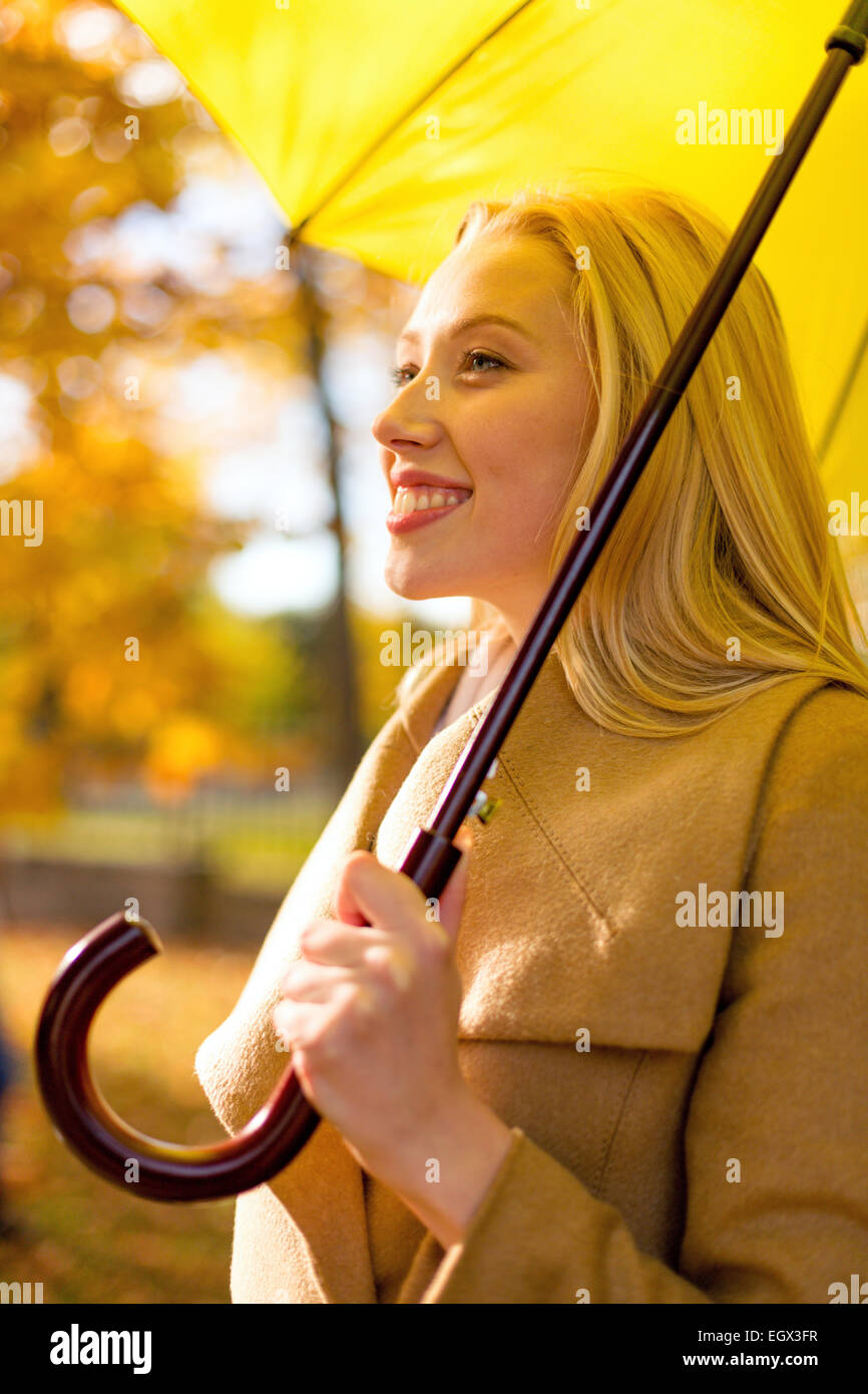 smiling woman with umbrella in autumn park Stock Photo - Alamy