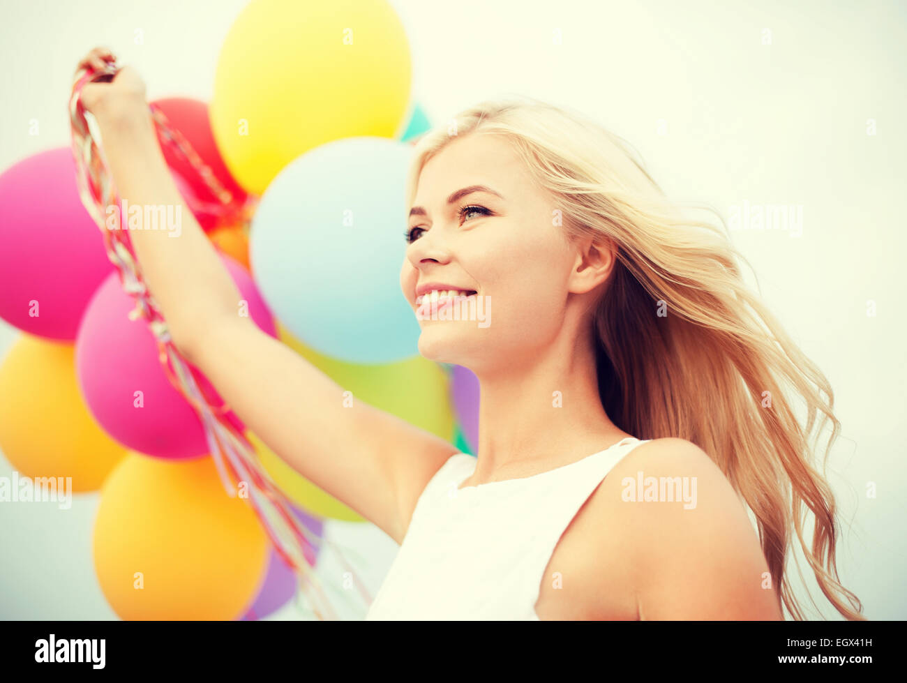 woman with colorful balloons outside Stock Photo