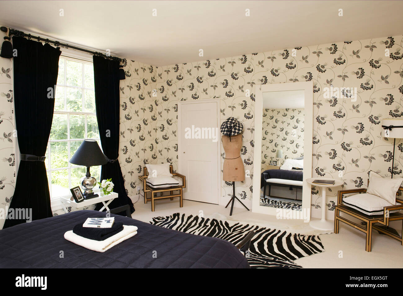 Dramatic black and white bedroom with patterned wallpaper Stock Photo ...