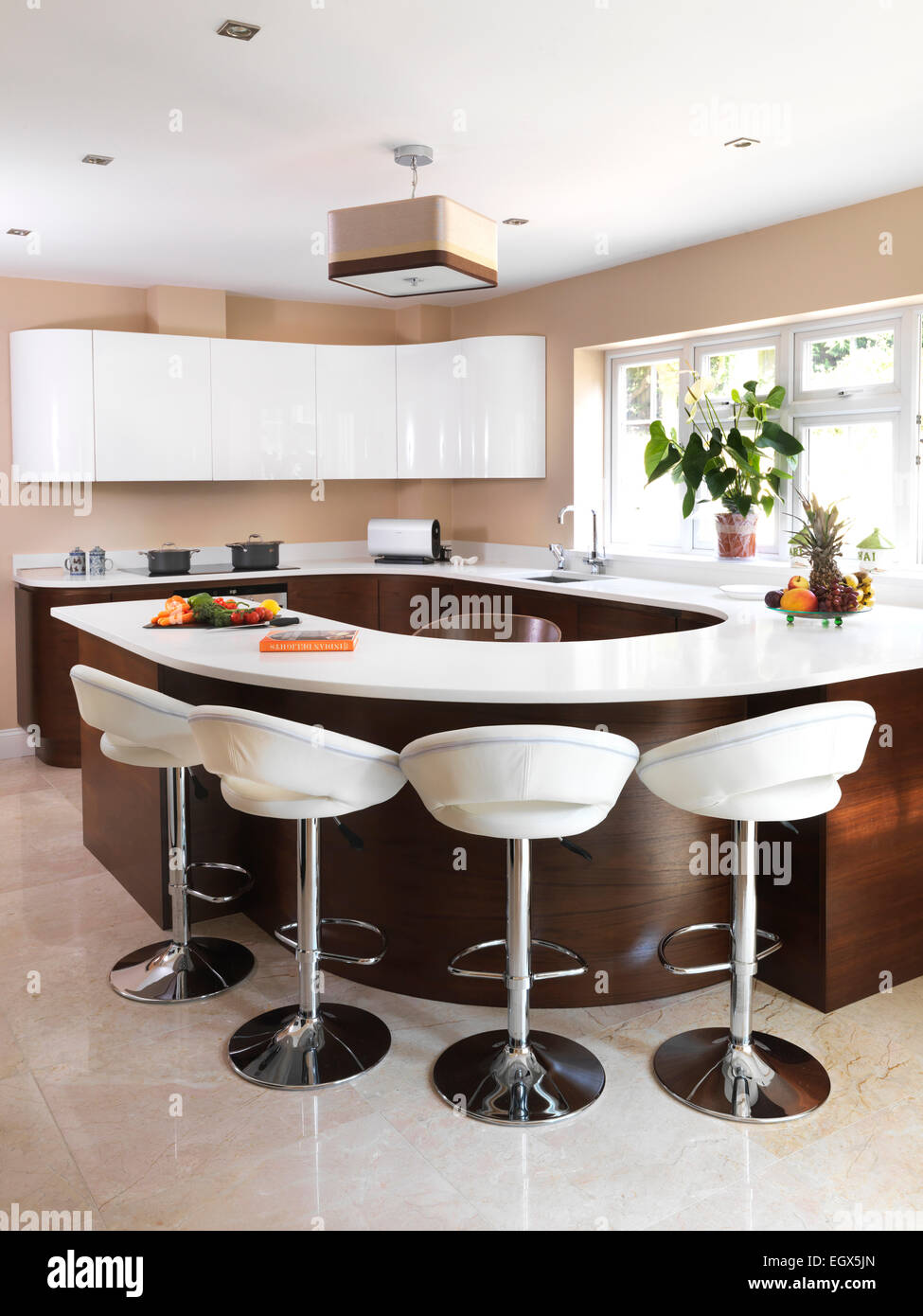 Bar Stools At Breakfast Bar In Modern Kitchen UK Home Stock Photo