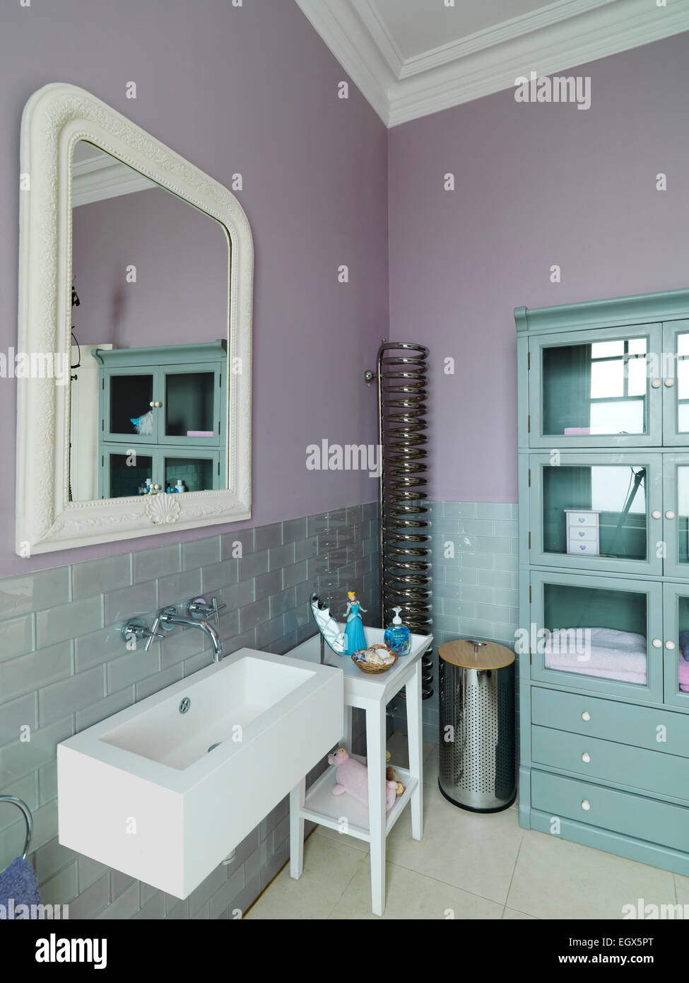 Mirror above washbasin in pink bathroom, UK home Stock Photo Alamy