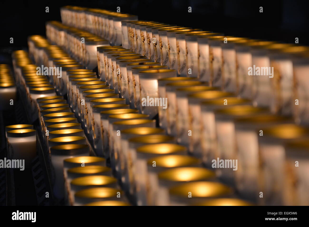 Dramatic picture of a lot of burning candles in a row Stock Photo