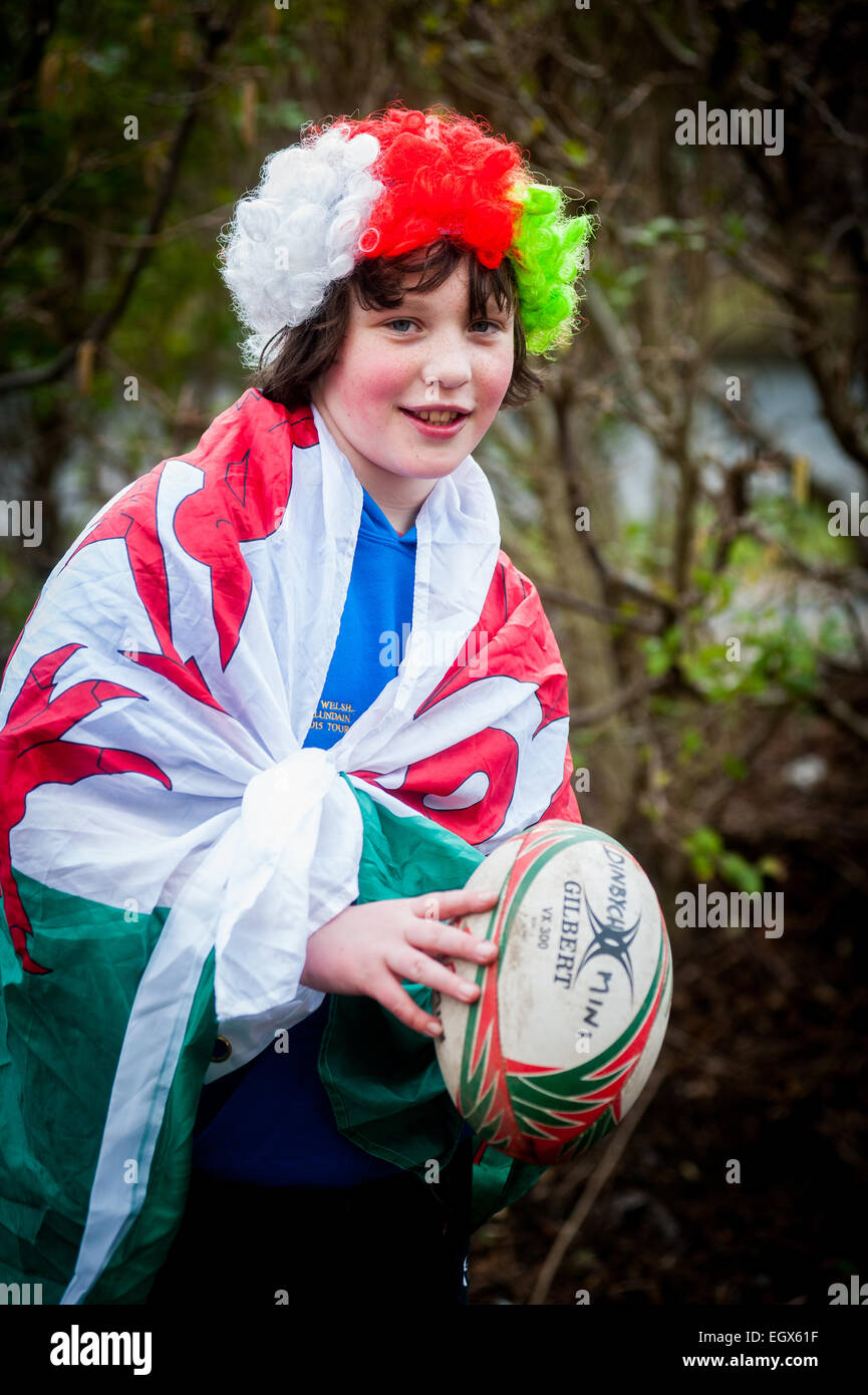 Boy draped in Welsh flag Welsh rugby supporters dressed up to watch London Welsh play on St.Davids Day Stock Photo