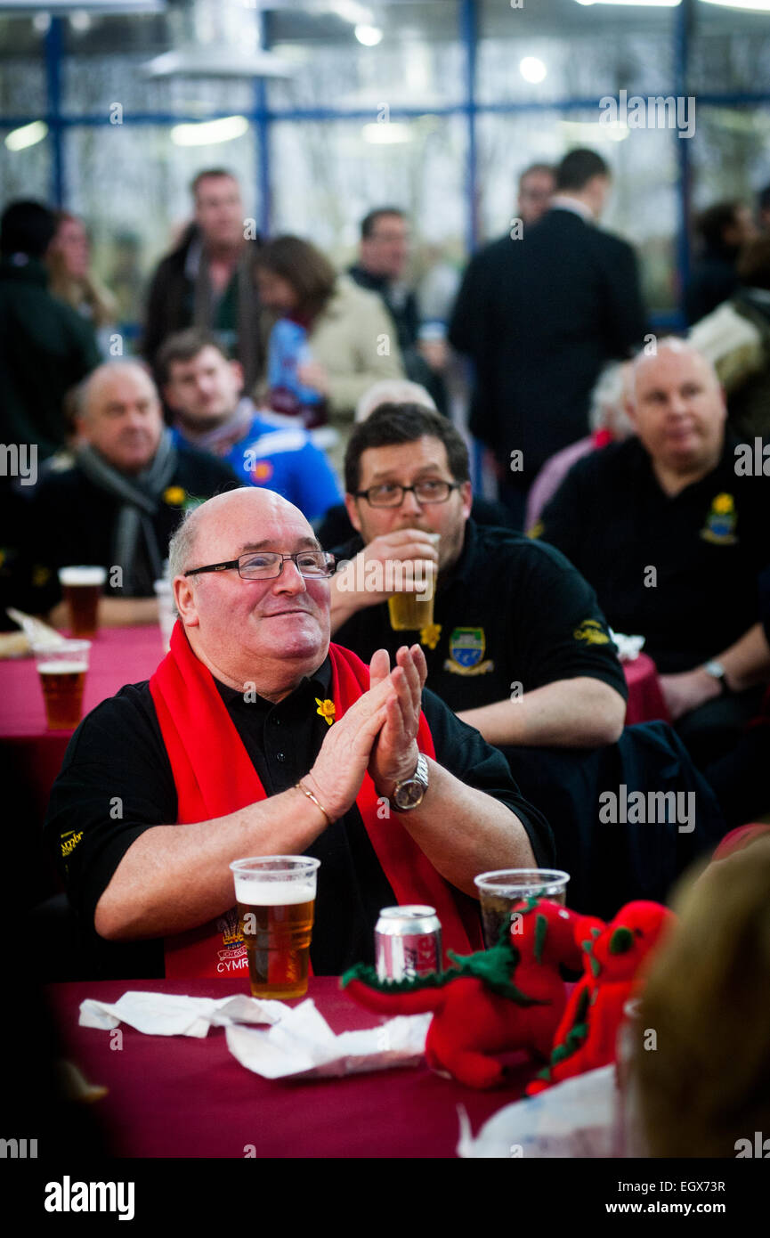 Welsh rugby supporters in scarves and shirts drinking in a bar before international rugby against France Stock Photo