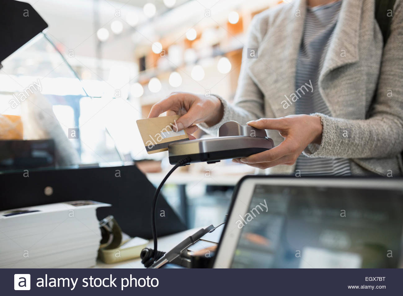 Customer paying at credit card reader in market Stock Photo