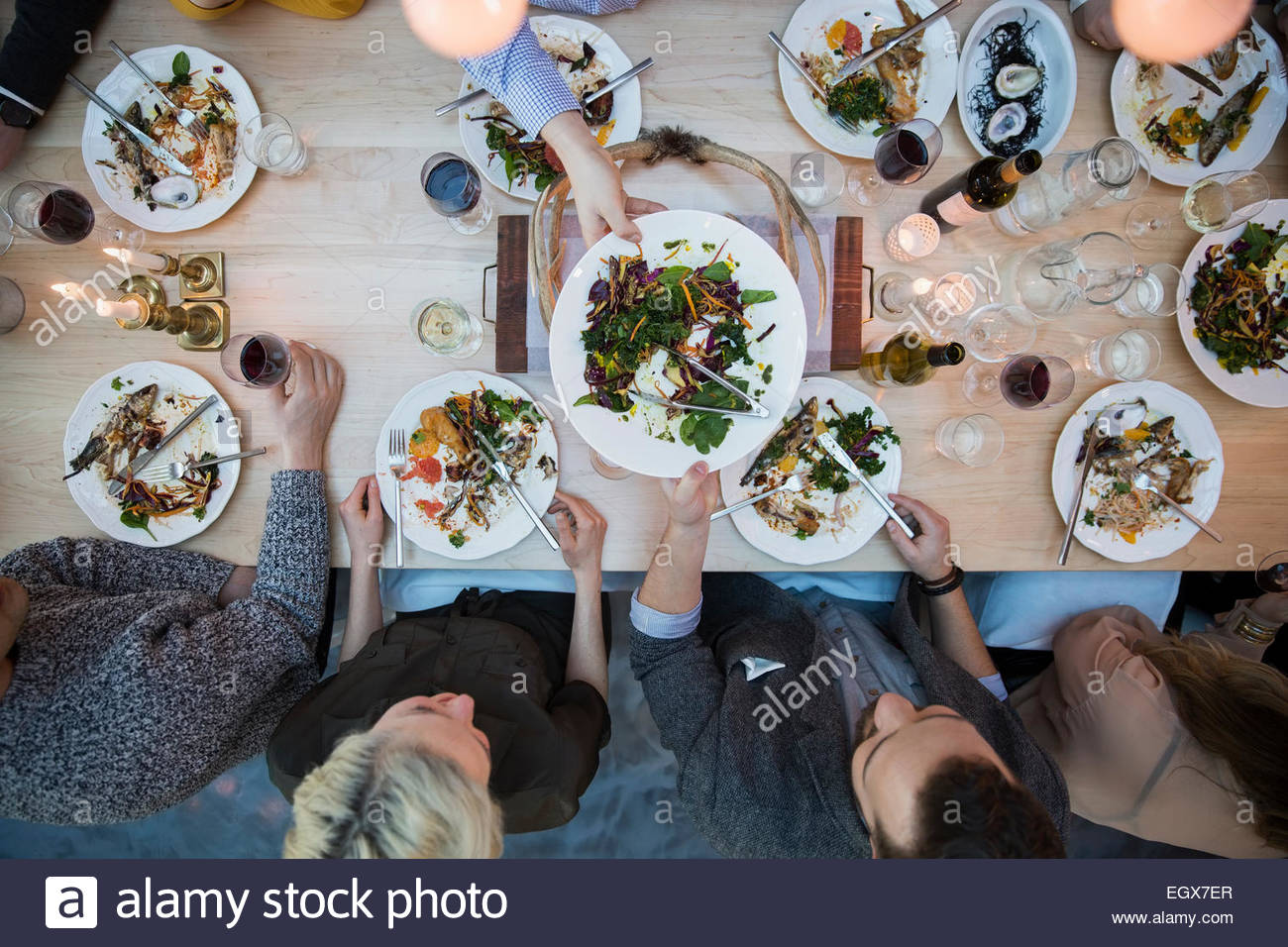 View from above friends eating at restaurant table Stock Photo