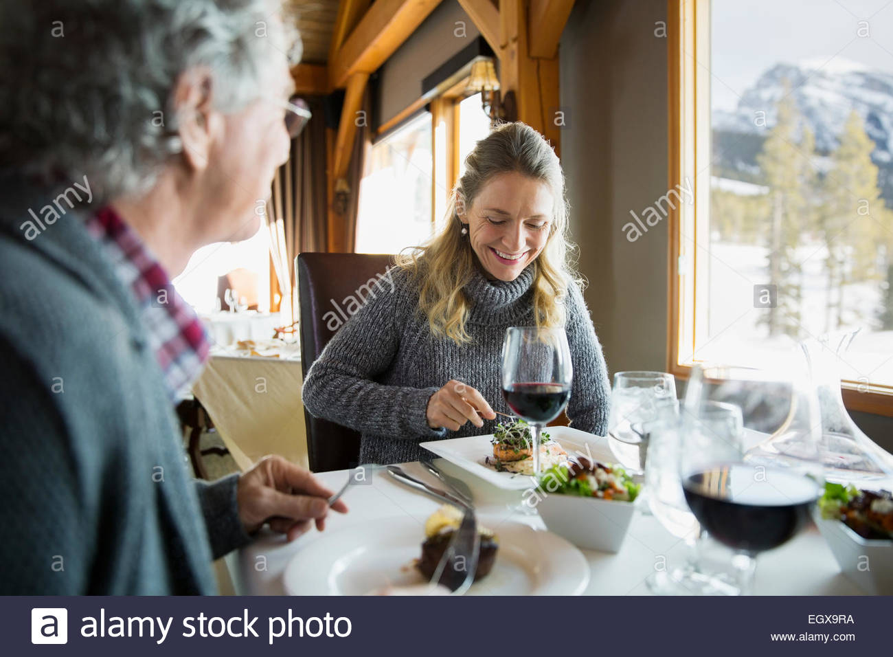 Couple eating at restaurant table Stock Photo