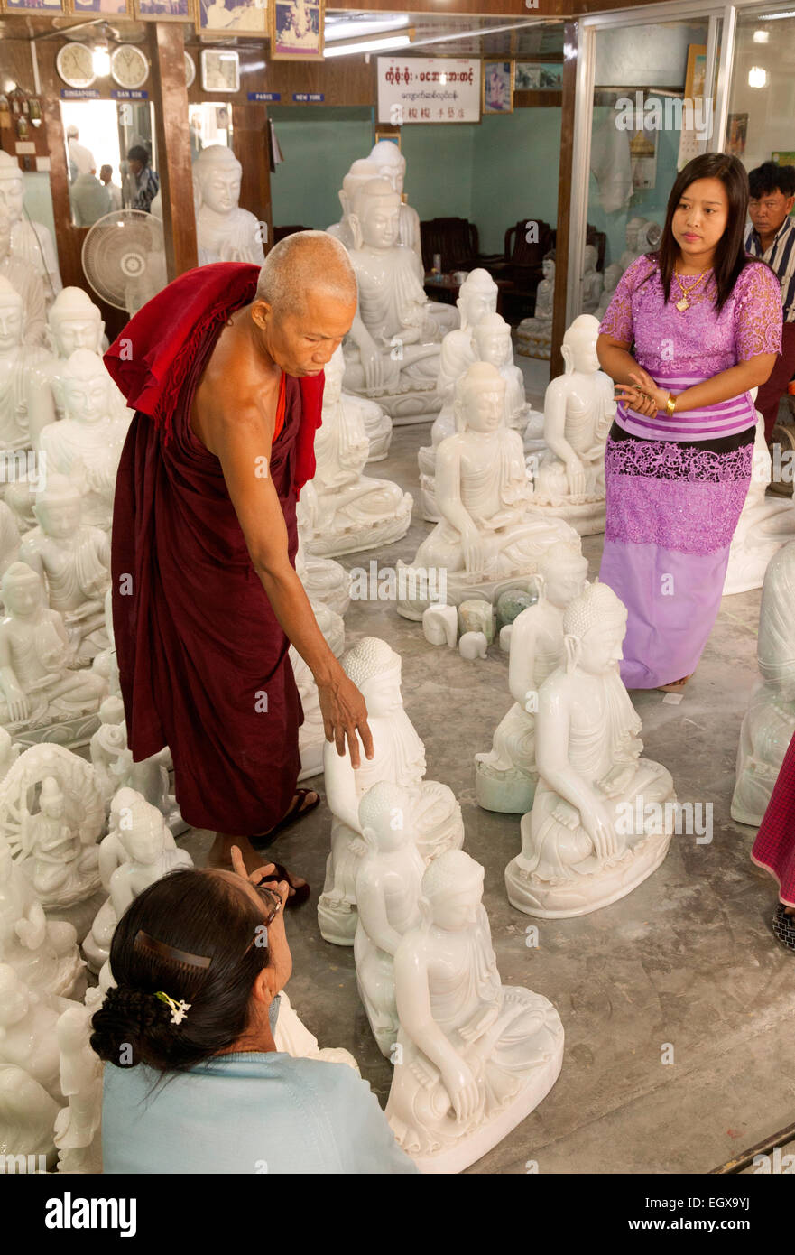 Buddhist monk shopping and buying a statue of Buddha, Mandalay, Myanmar ( burma ), Asia Stock Photo