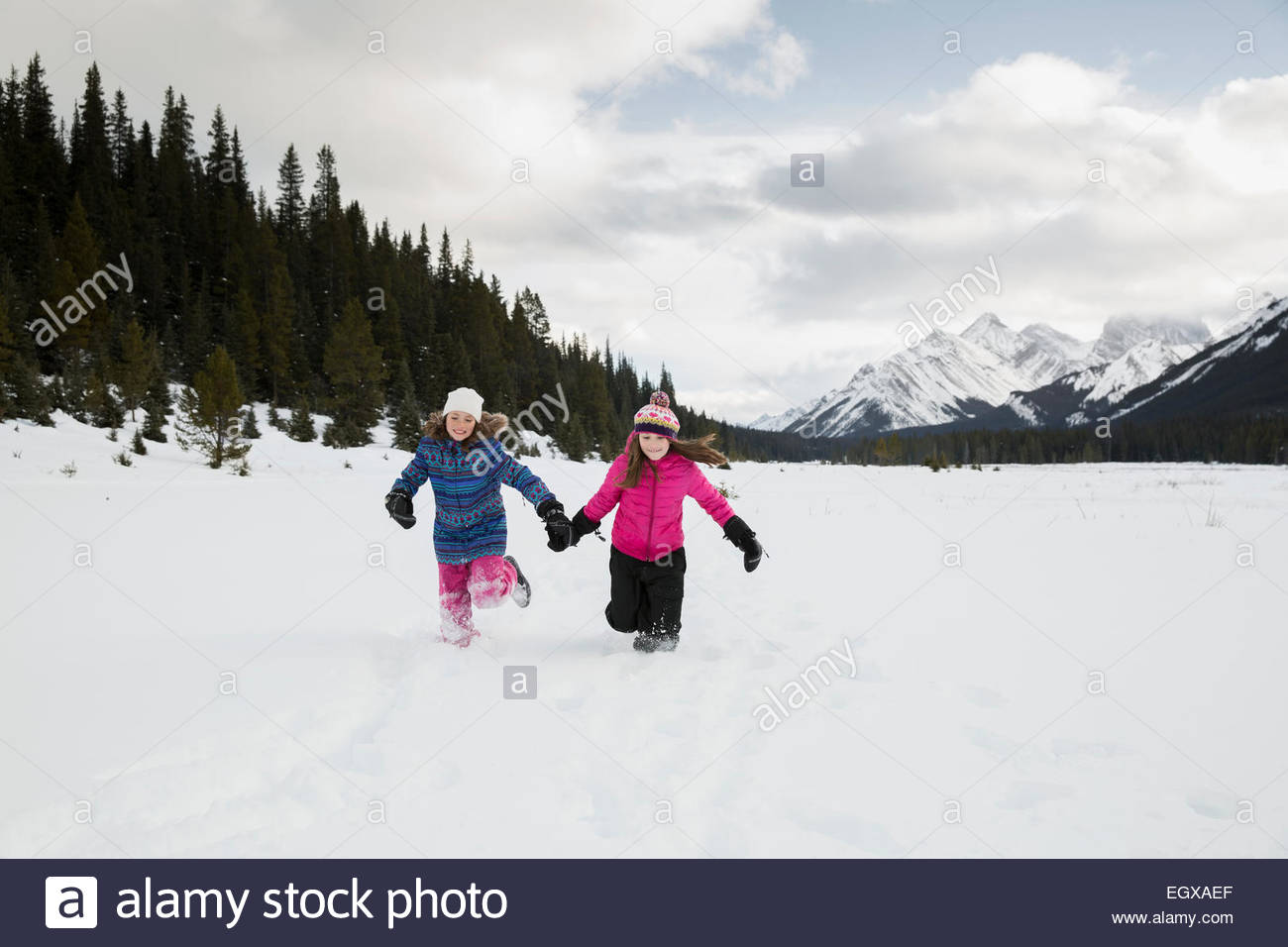 Two girls running holding hands hi-res stock photography and images - Alamy