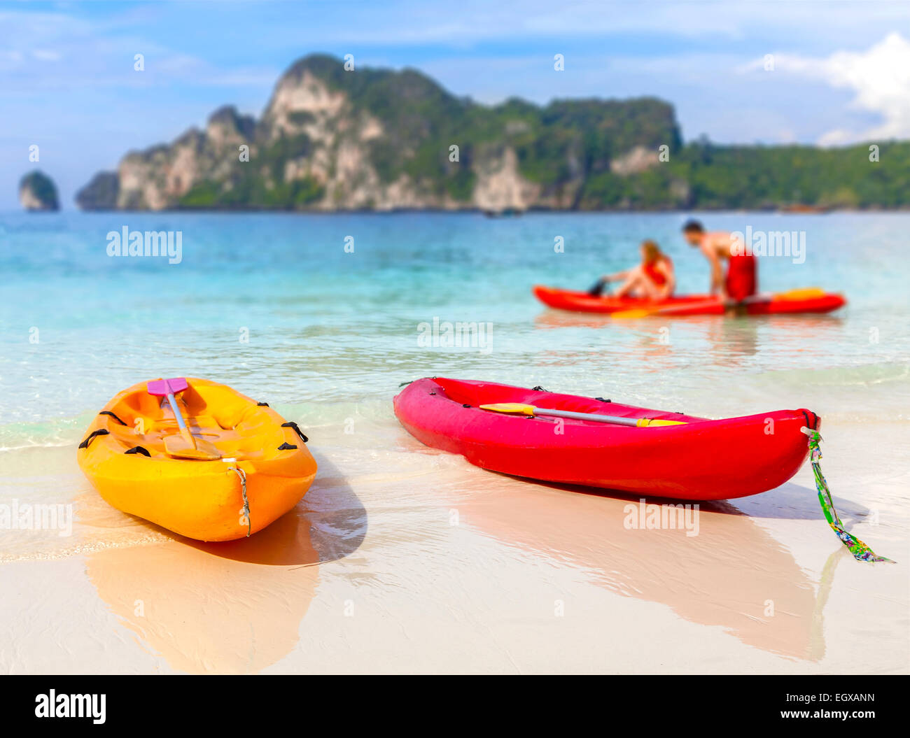Kayaks on a tropical beach, shallow depth of field. Active holidays background. Stock Photo