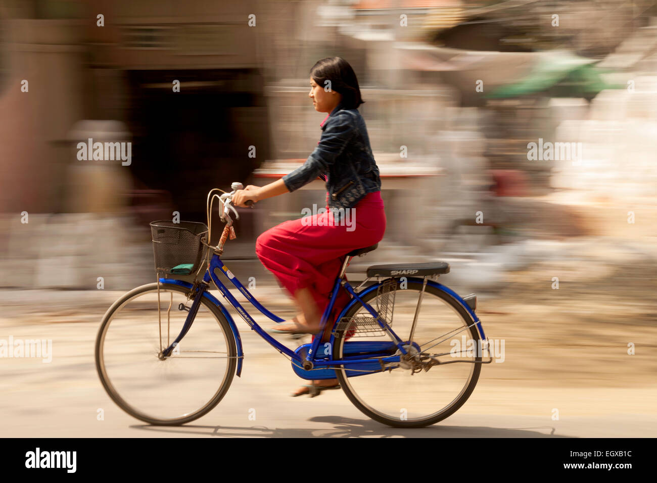 Burmese woman riding a bicycle, Mandalay, Myanmar ( Burma ), Asia Stock Photo