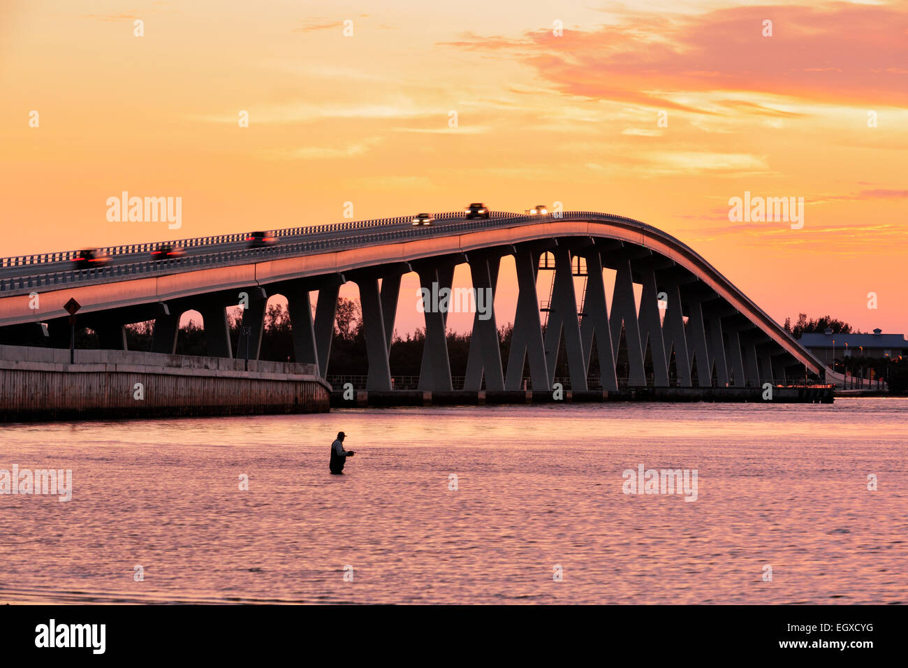 Sanibel Causeway bridge at sunrise with fisherman Sanibel Island Fort Myers Florida USA Stock Photo