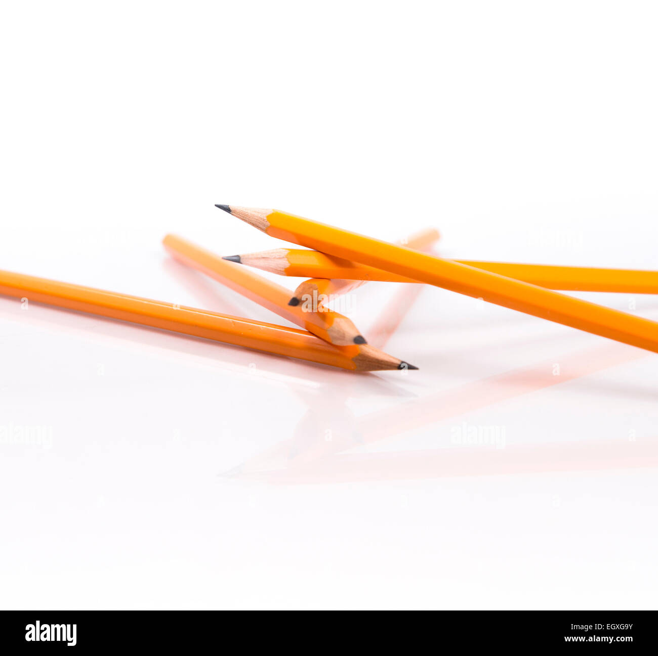 Five Orange Pencils Stacked Stock Photo
