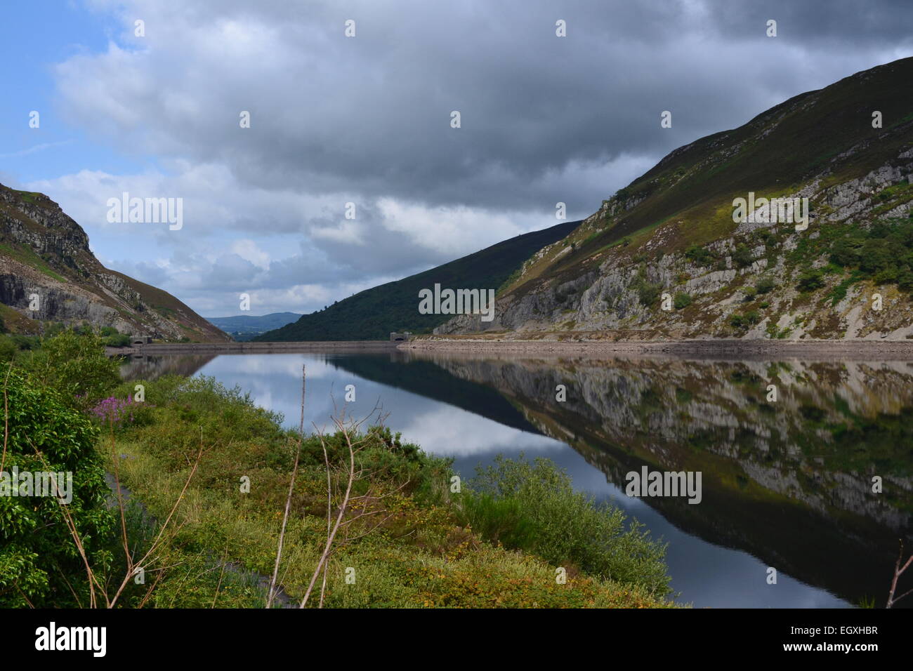 Caban Coch Reservoir, Elan Valley reservoir,  Rhayader Wales UK summers day still water reflecting the hillside sky clouds Stock Photo