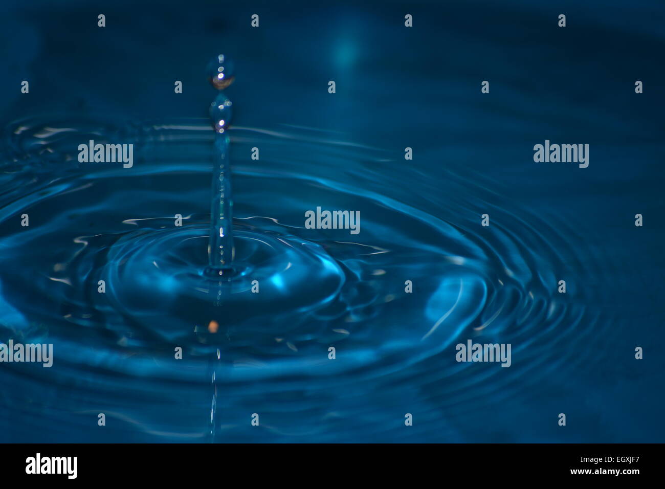 Water drop impact frozen mid splash with ripples and droplets Stock ...