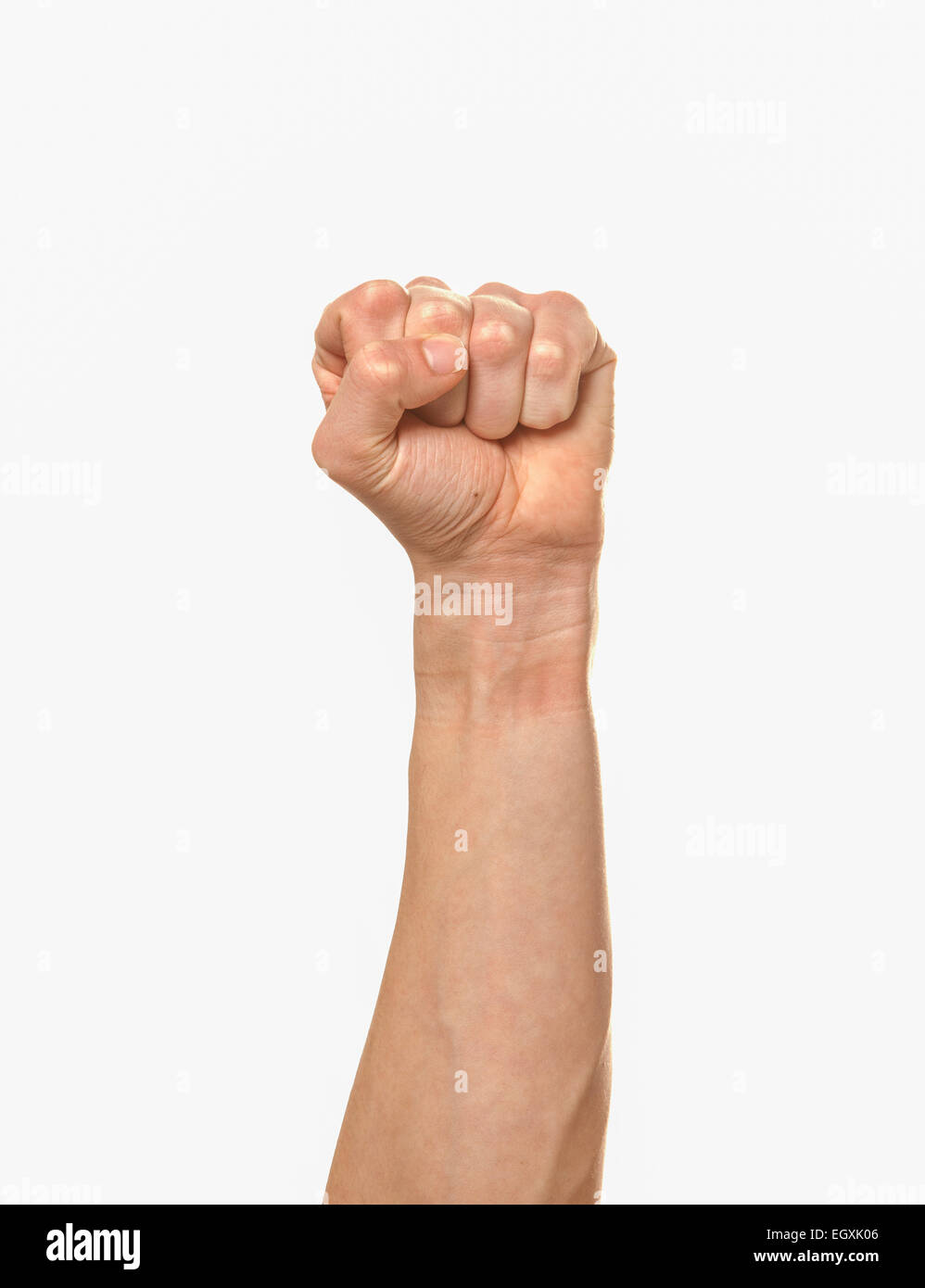 An arm extended with a clenched fist. Stock Photo