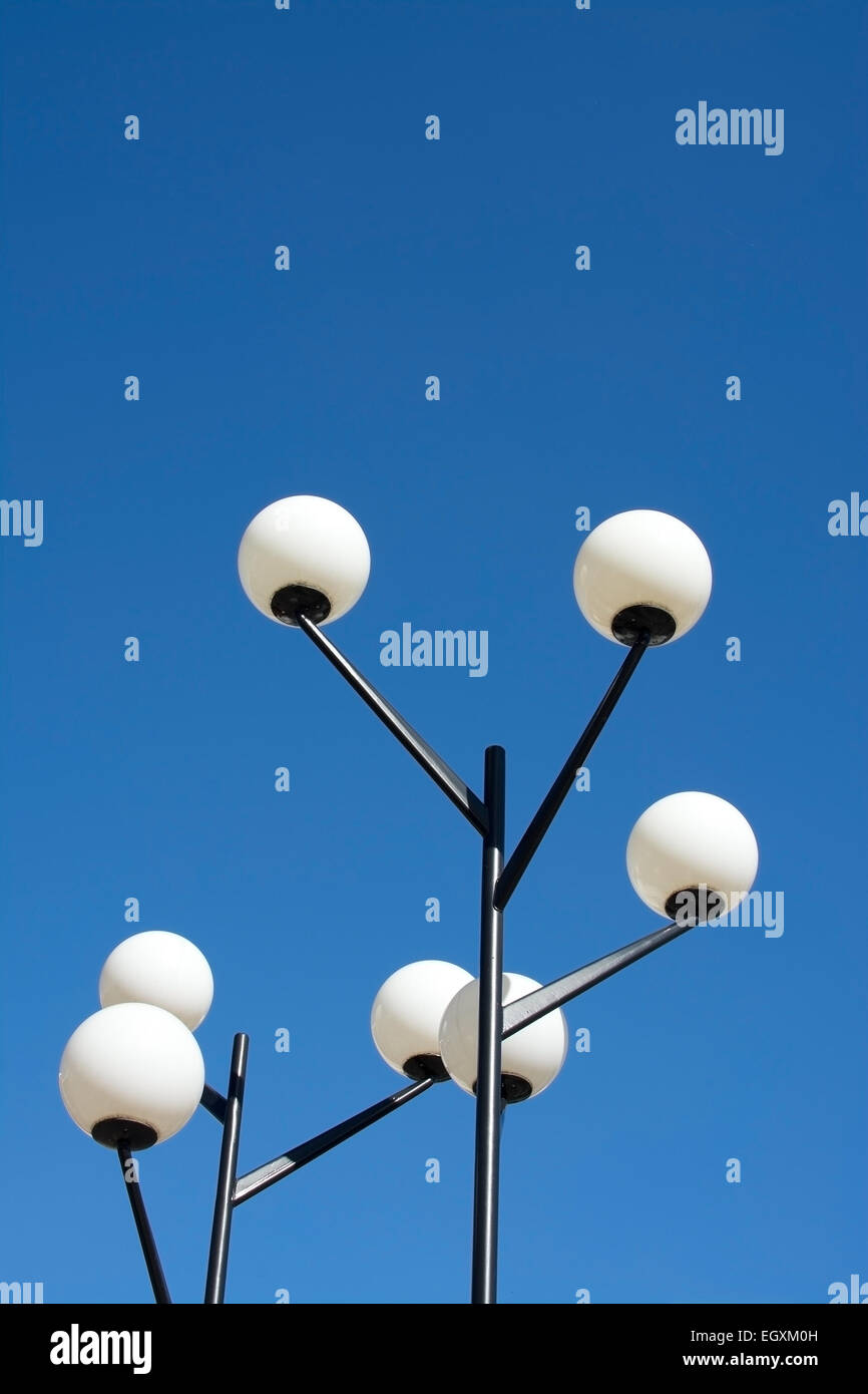 Round fifties lamps with white opaque glass globes on black metal posts - fifties modernist suburb Vallingby, Stockholm, Sweden. Stock Photo