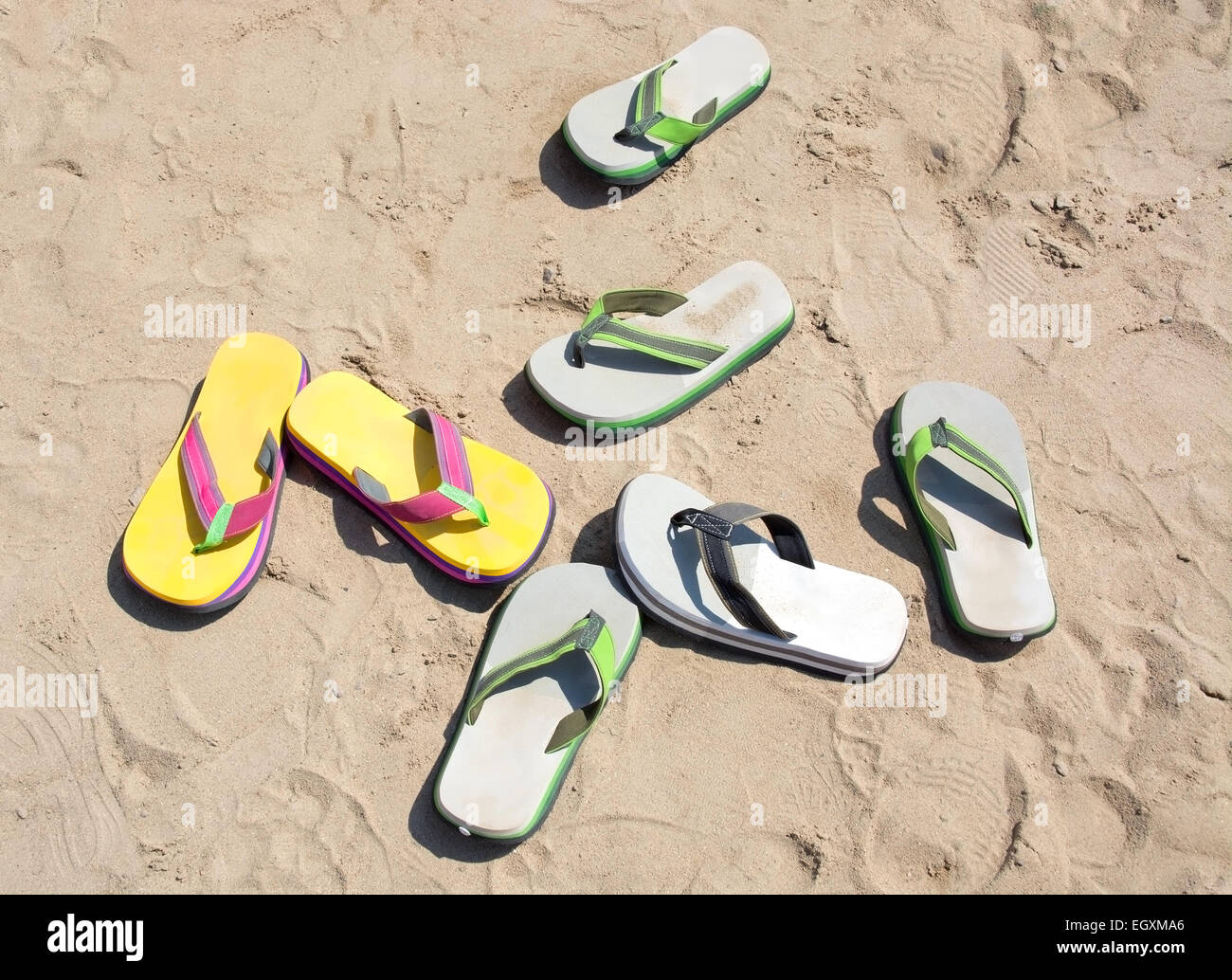 Odd number of flipflops in the sand Stock Photo - Alamy