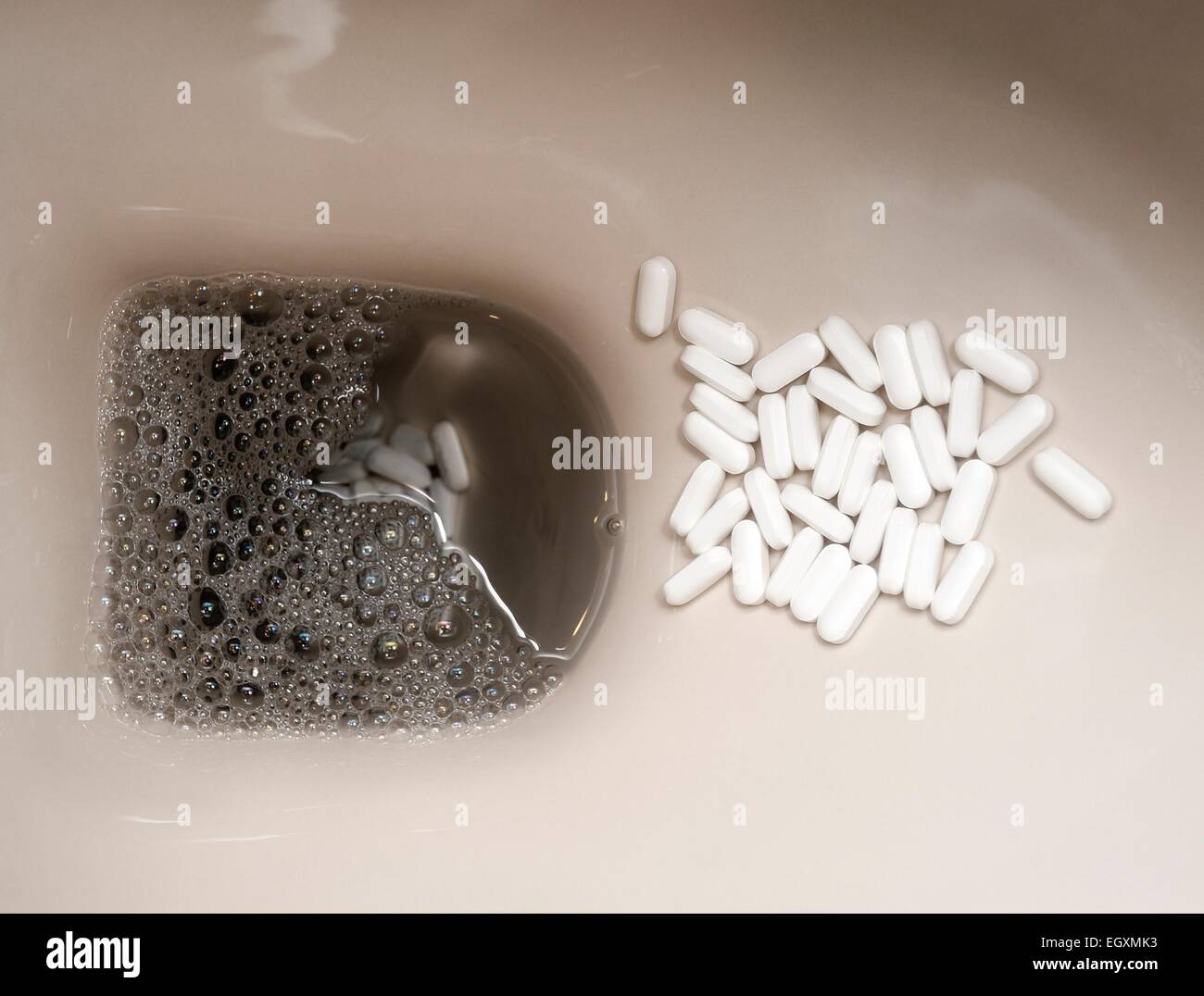 Prescription Tablets waiting to be flushed down a domestic toilet bowl