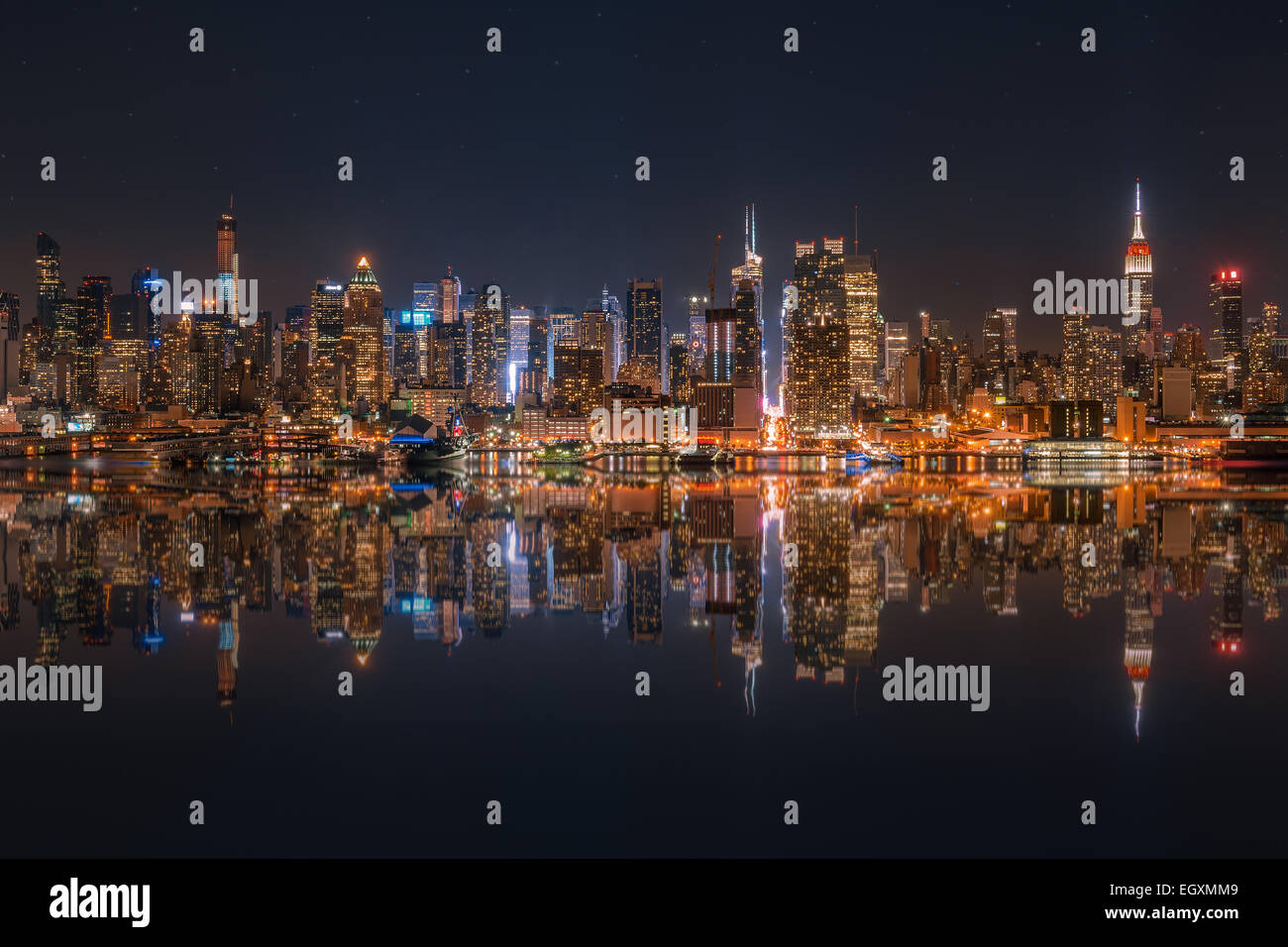 Lower Manhattan skyline at night reflected in water Stock Photo - Alamy