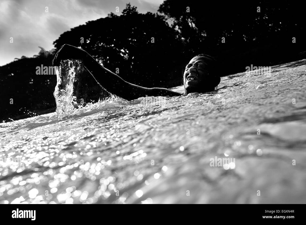 A Colombian sand miner dives under the water to extract sand from the bottom of the river La Vieja in Cartago, Colombia. Stock Photo