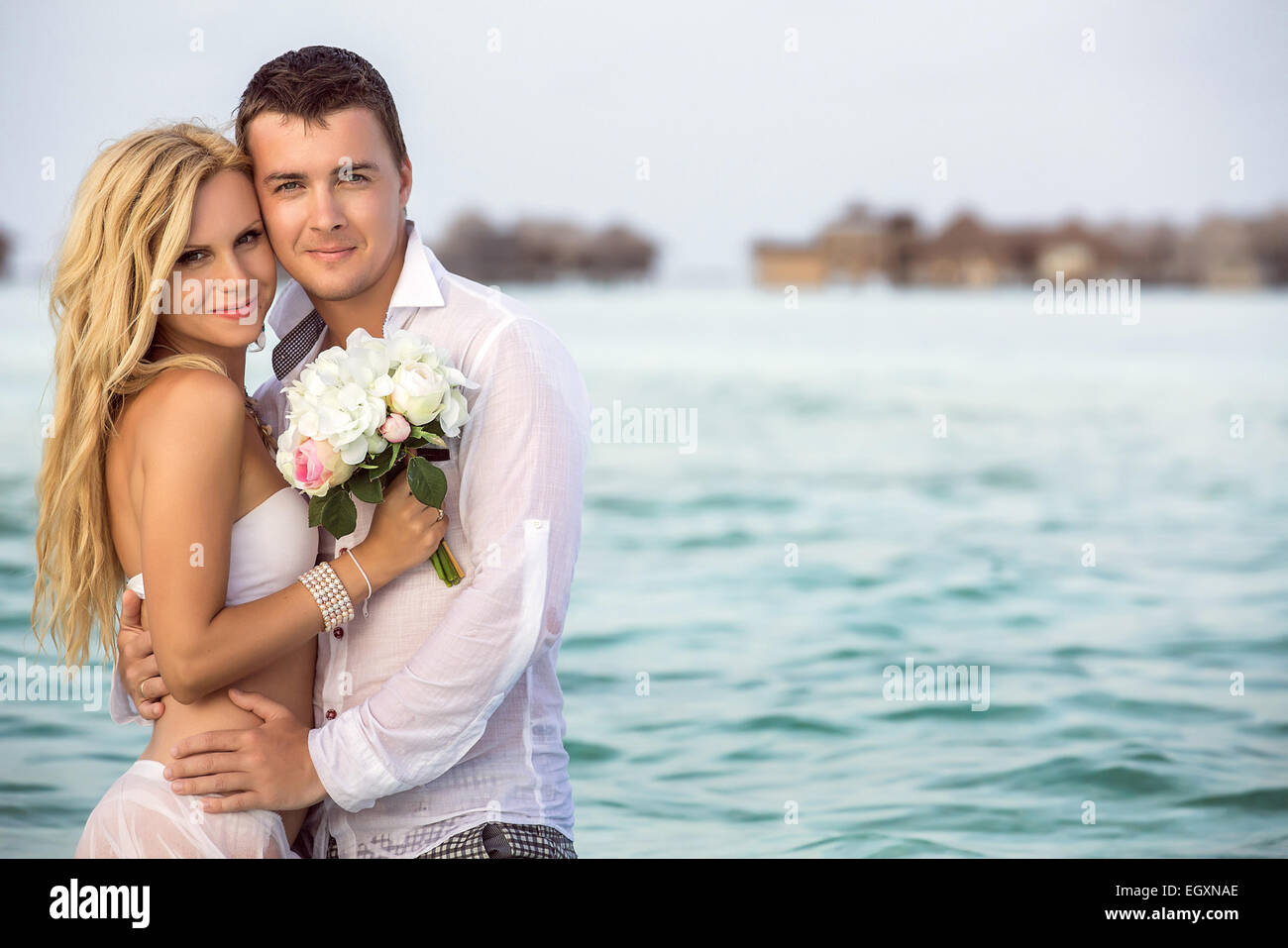 Couple men women tropical beach hi-res stock photography and images - Alamy