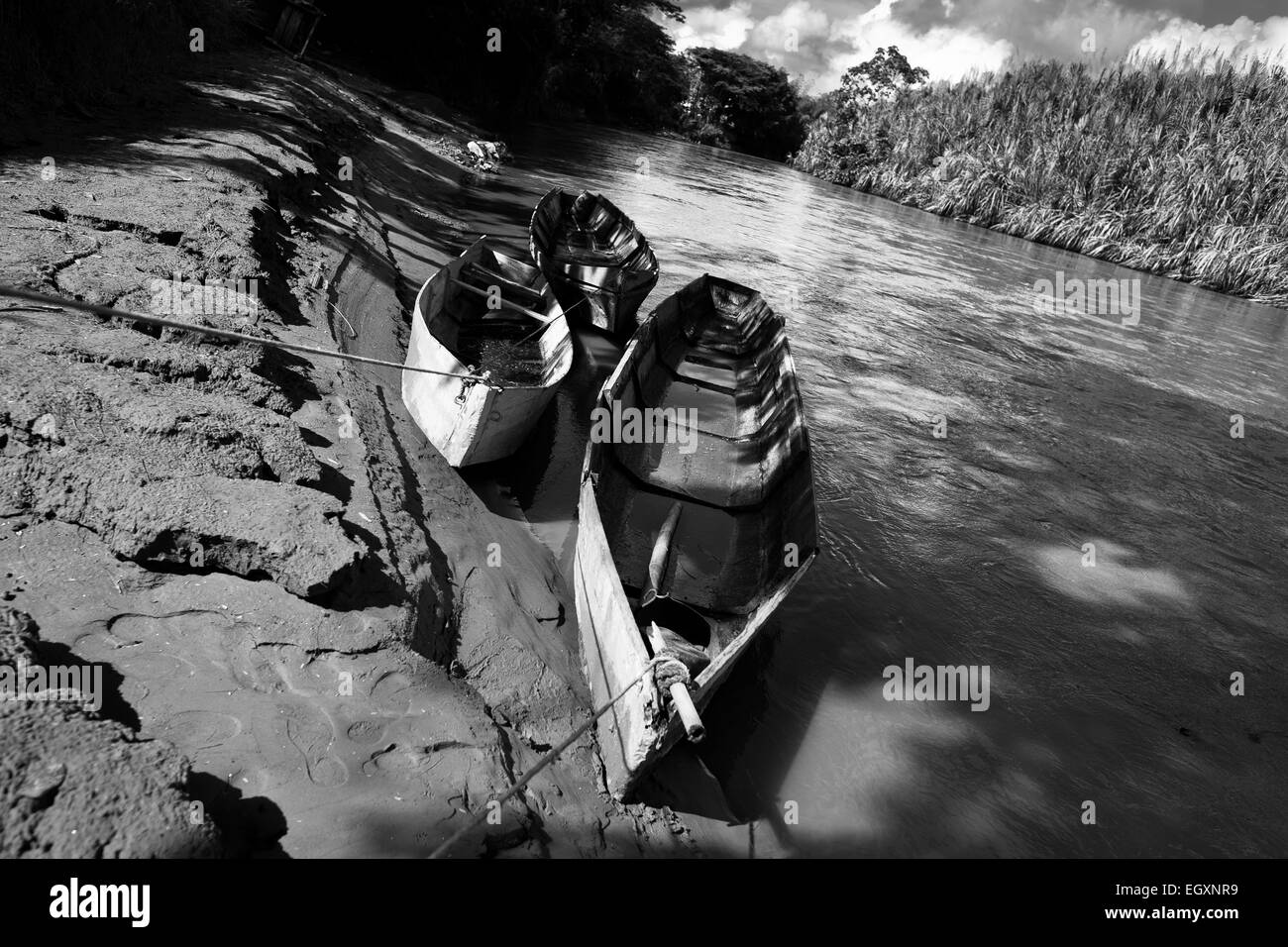 Boats of Colombian sand miners are seen tied up at the bank of the river La Vieja in Cartago, Colombia. Stock Photo