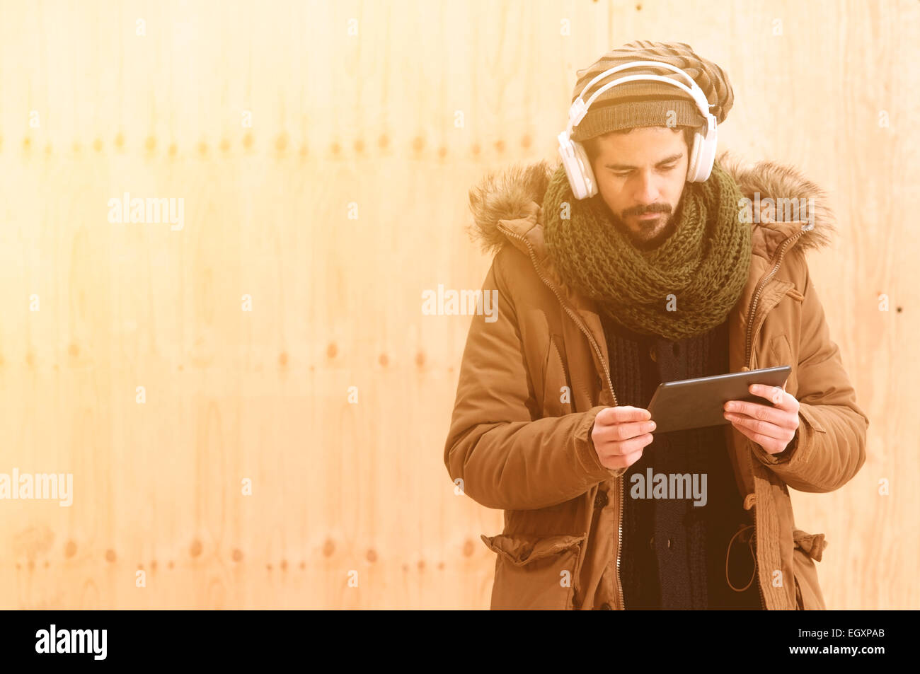 a young man listens to music in an urban image of modern life istagram style toned Stock Photo