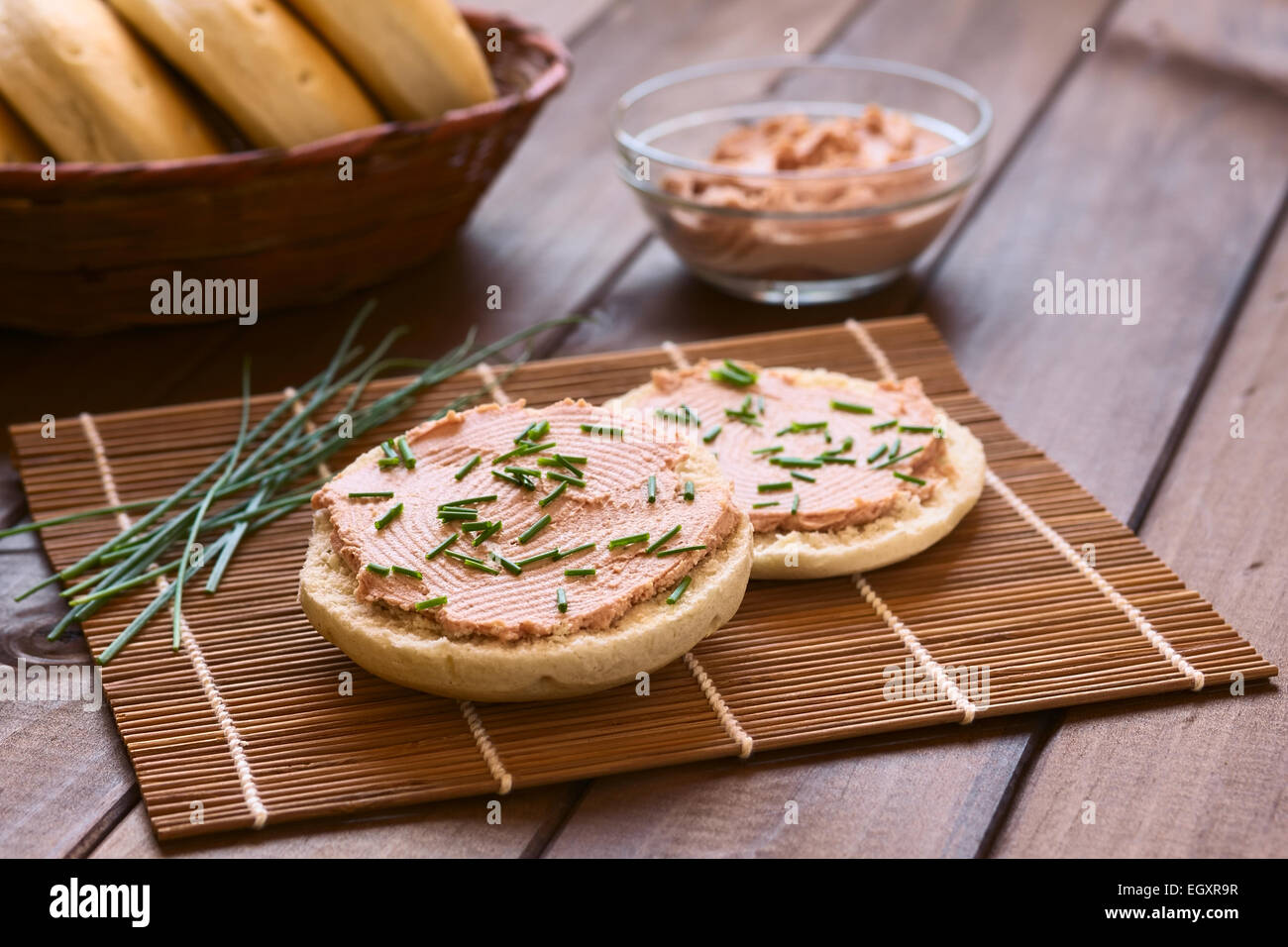 Liverwurst spread on bun with chives photographed with natural light