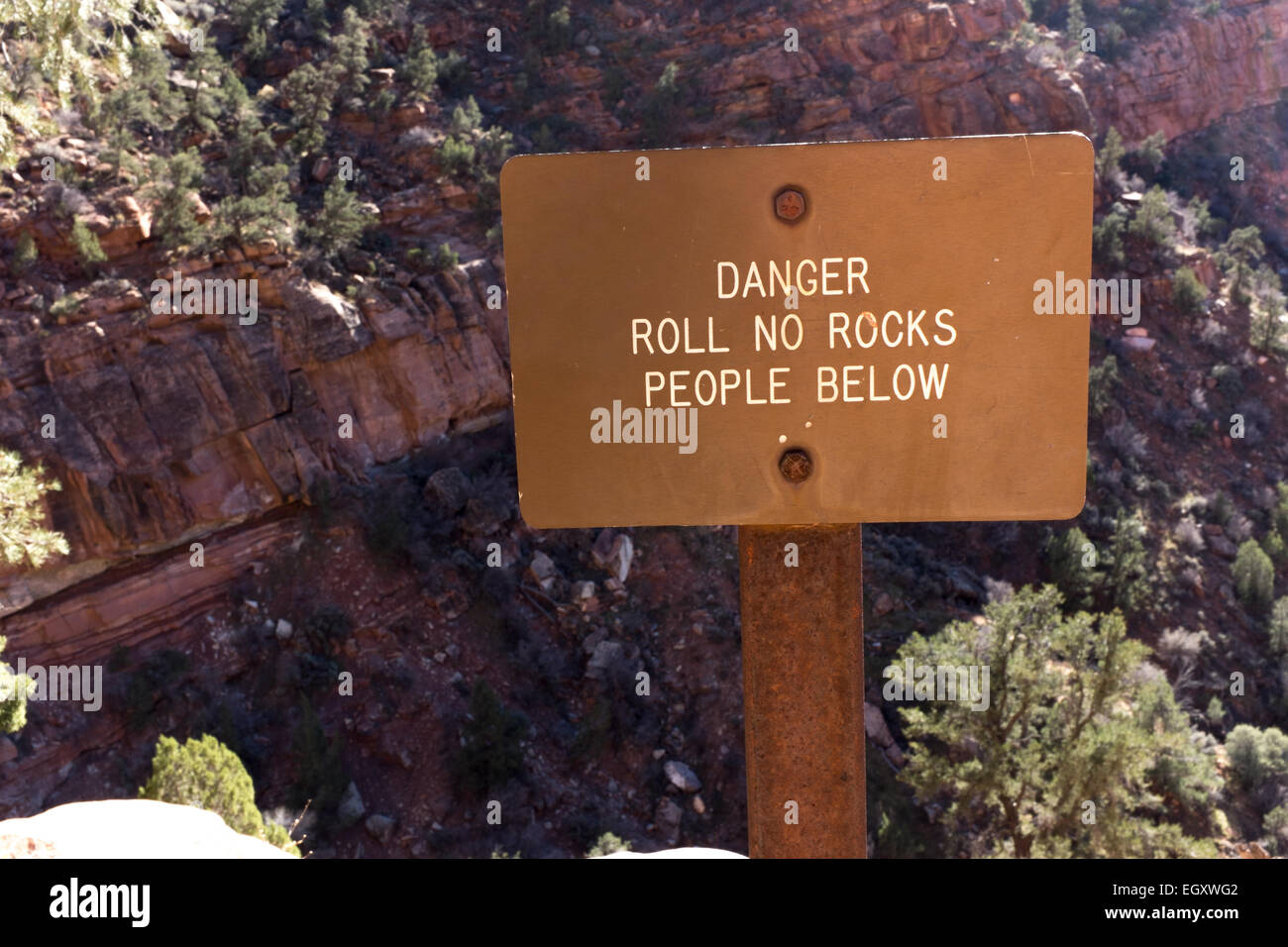 Sign that reads Danger Roll No Rocks People Below Stock Photo Alamy