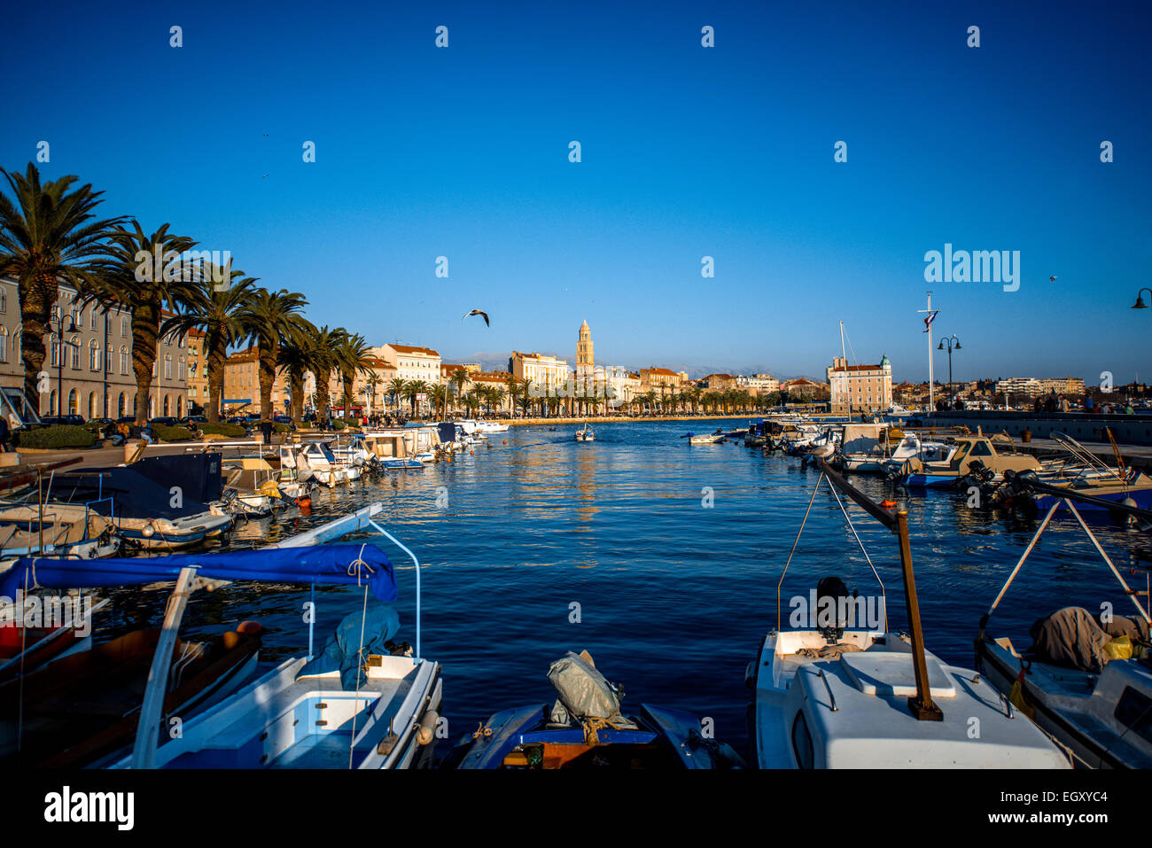 Split city centre view from the quay with boats and yachts in the sunny evening in Croatia Stock Photo