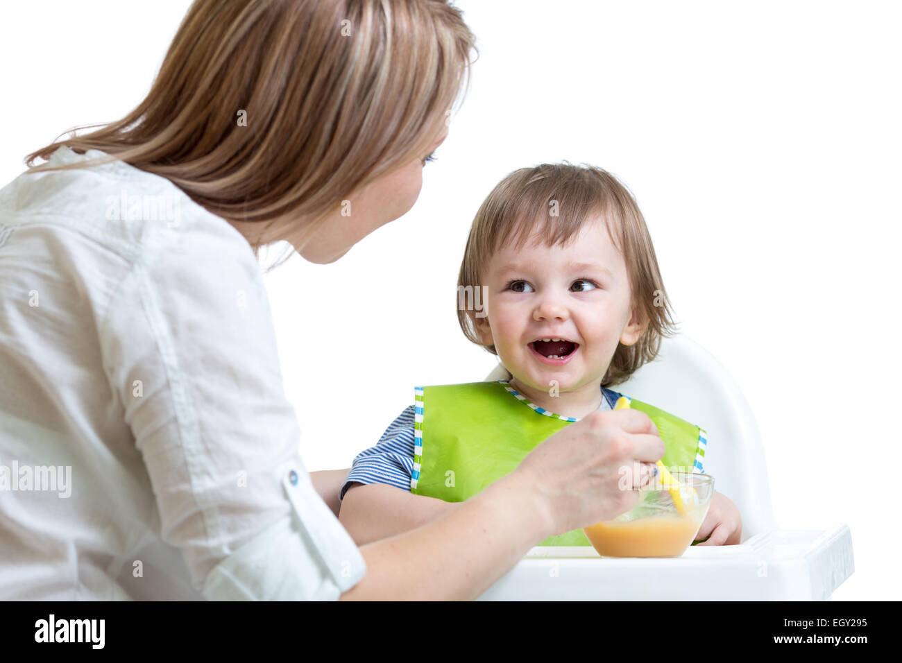 mother feeding toddler boy Stock Photo
