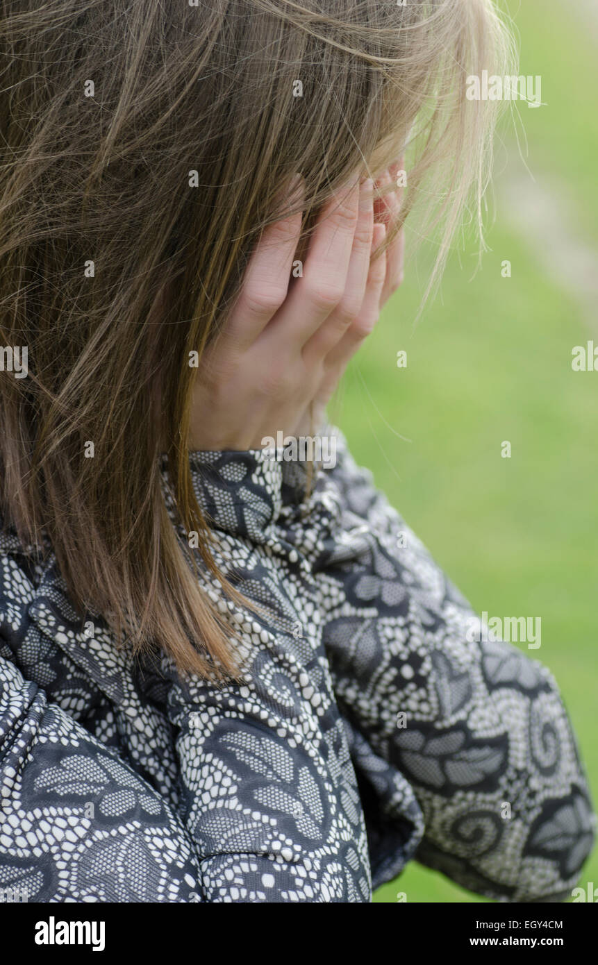 Young woman crying head in hands Stock Photo