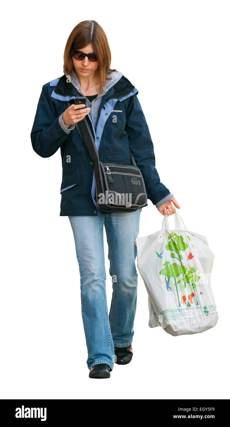 Woman texting on mobile phone in the street Stock Photo