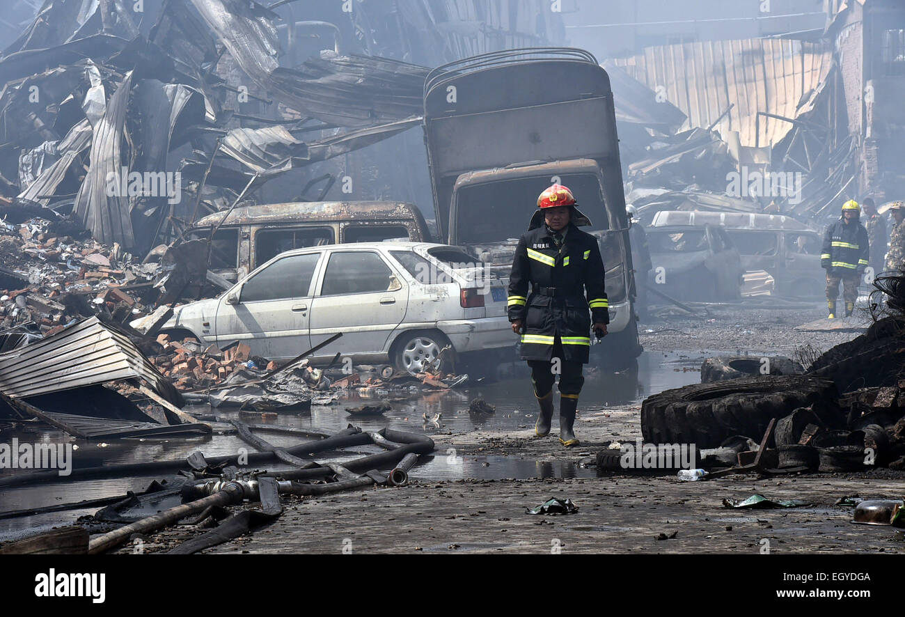 Kunming, China's Yunnan Province. 4th Mar, 2015. Firefighters work at the fire site of Dongmeng Lianfeng Agricultral Trade Center in the Guandu District of Kunming, capital of southwest China's Yunnan Province, March 4, 2015. Nine people were killed and 10 others injured after a fire engulfed the agricultural trade center early Wednesday morning. The blaze, which has been put out, destroyed more than 50 stores and burned an area covering more than 3,300 square meters. Credit:  Chen Haining/Xinhua/Alamy Live News Stock Photo