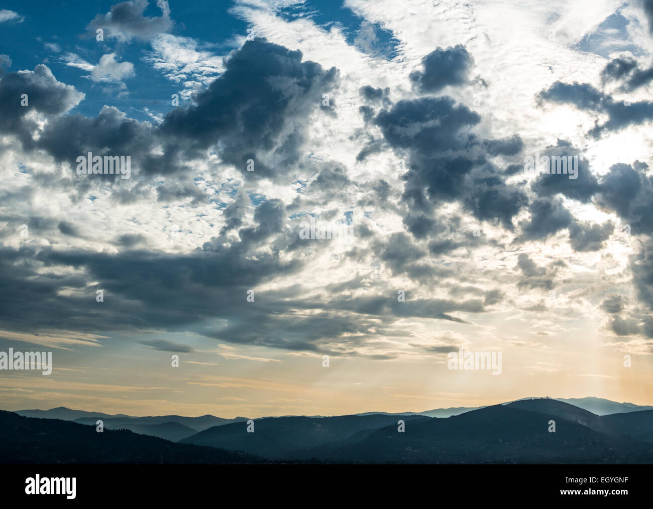 Dramatic clouds and silhouette of hills, twilight, Tuscany, Italy Stock Photo