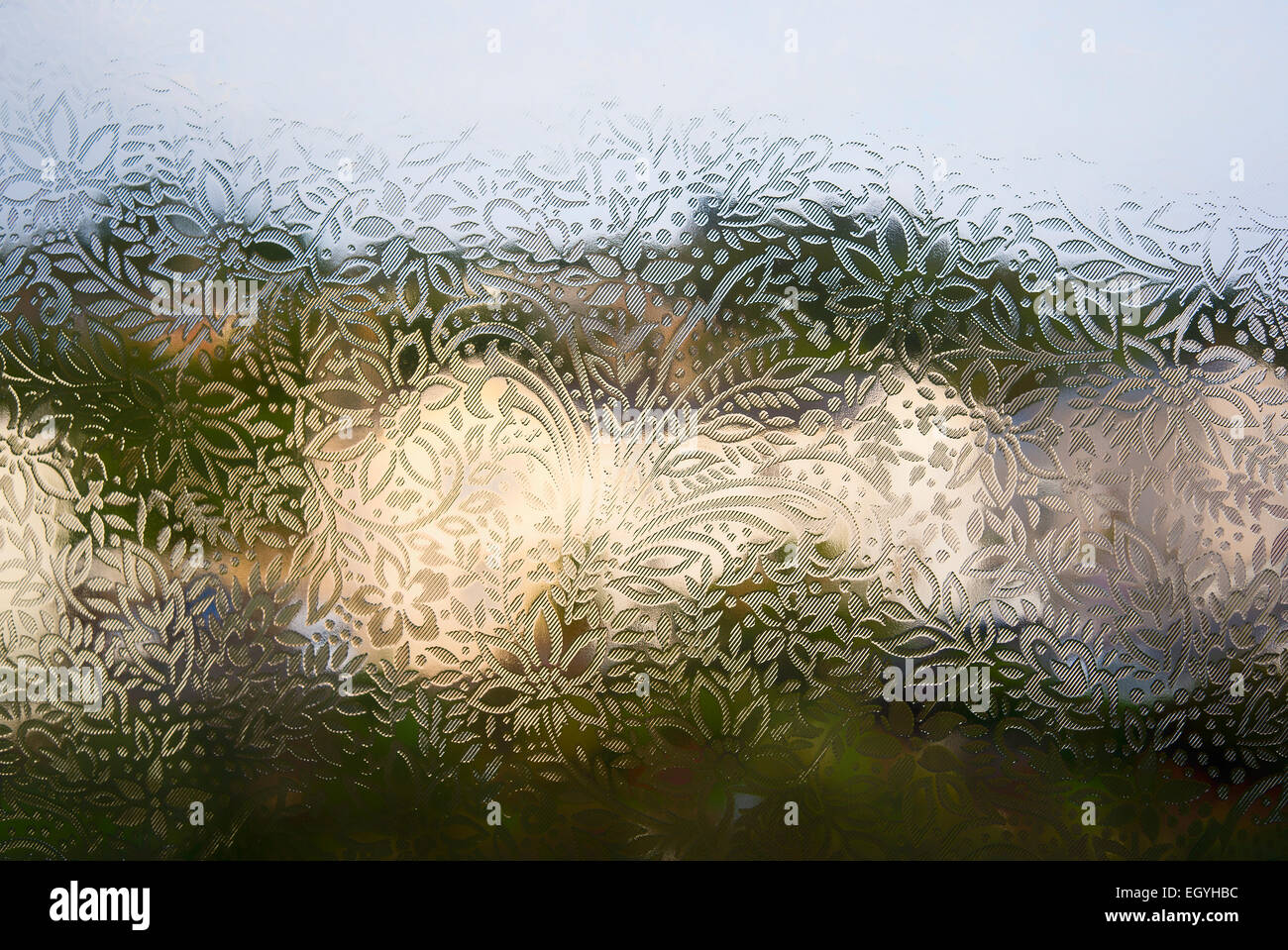 Frosted floral patterned glass in a domestic urban window Stock Photo