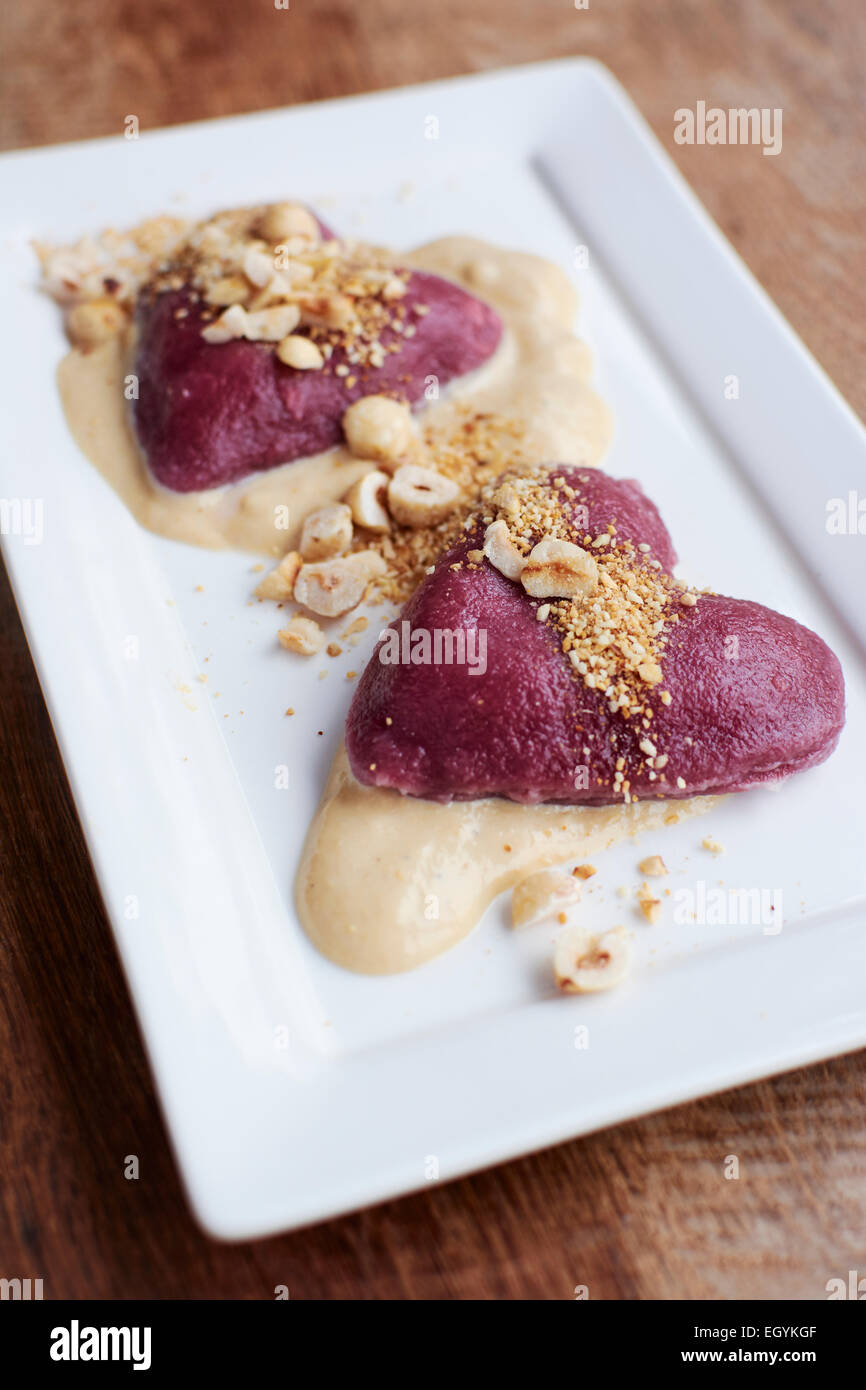Beet ravioli with vegan hazelnut cheese sauce Stock Photo Alamy