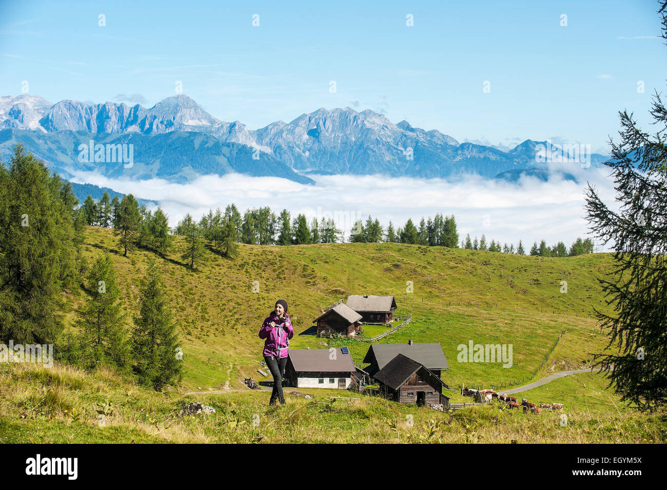Austria, Altenmarkt-Zauchensee, young woman hiking in alpine landscape Stock Photo