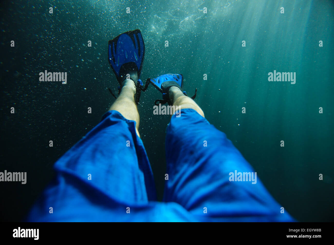 Swimmer wearing diving fins underwater Stock Photo Alamy