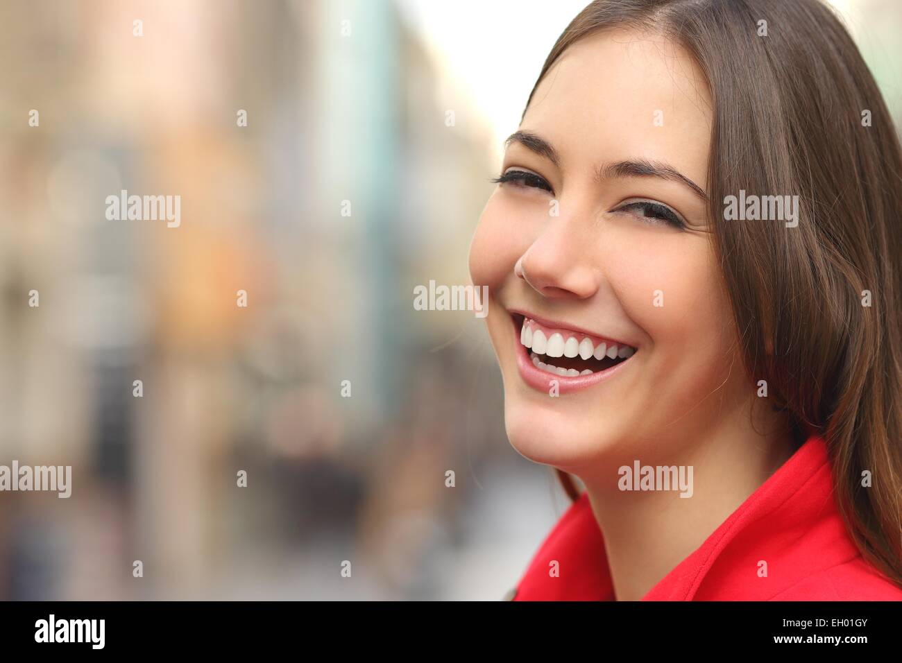 Woman white smile with a perfect teeth in the street and looking at camera Stock Photo