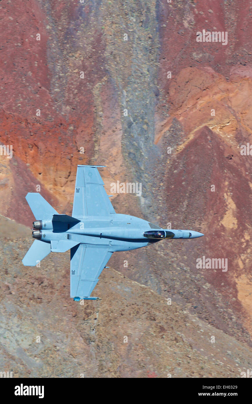 United States Navy F-18 Super Hornet, Flying At Low Level Through A Desert Canyon. Stock Photo