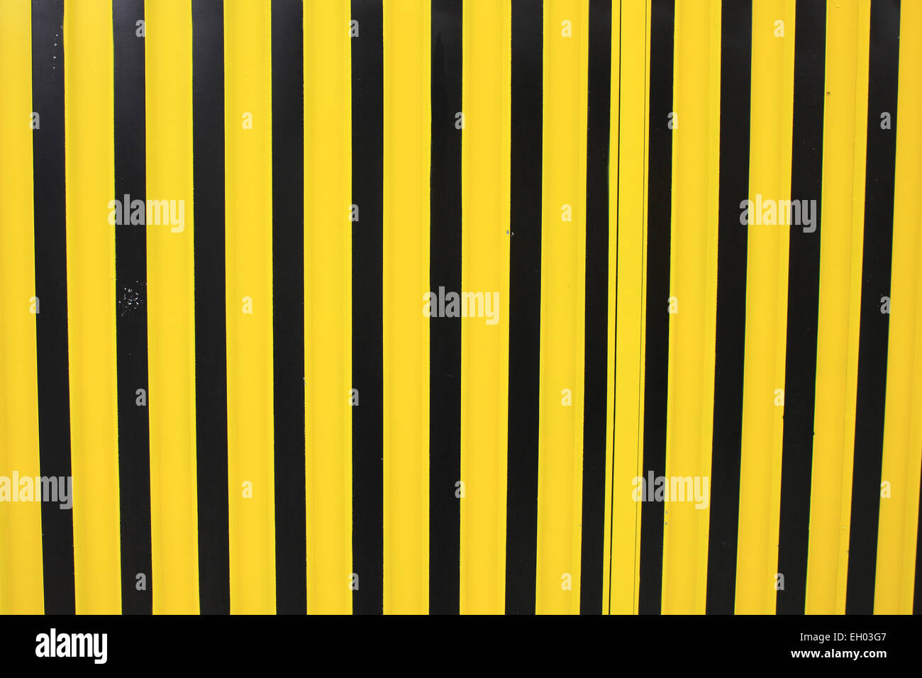 Yellow and black stripes on a steel gate in Otavalo, Ecuador Stock