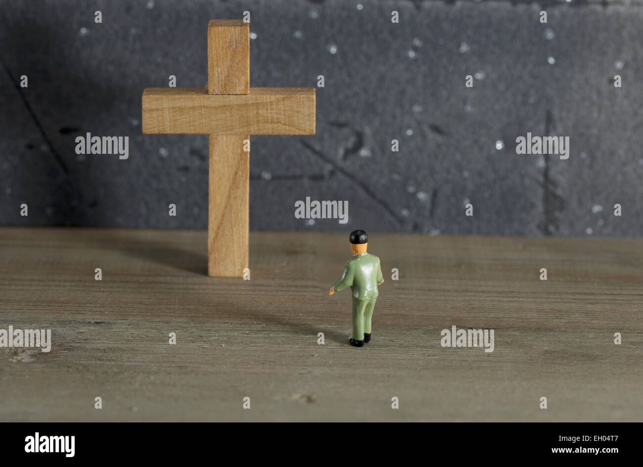 puppet man toy looking at empty cross Stock Photo