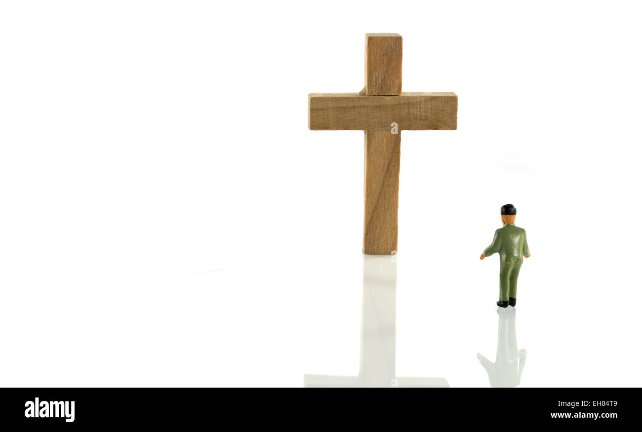 man looking at empty wooden cross isolated on white Stock Photo