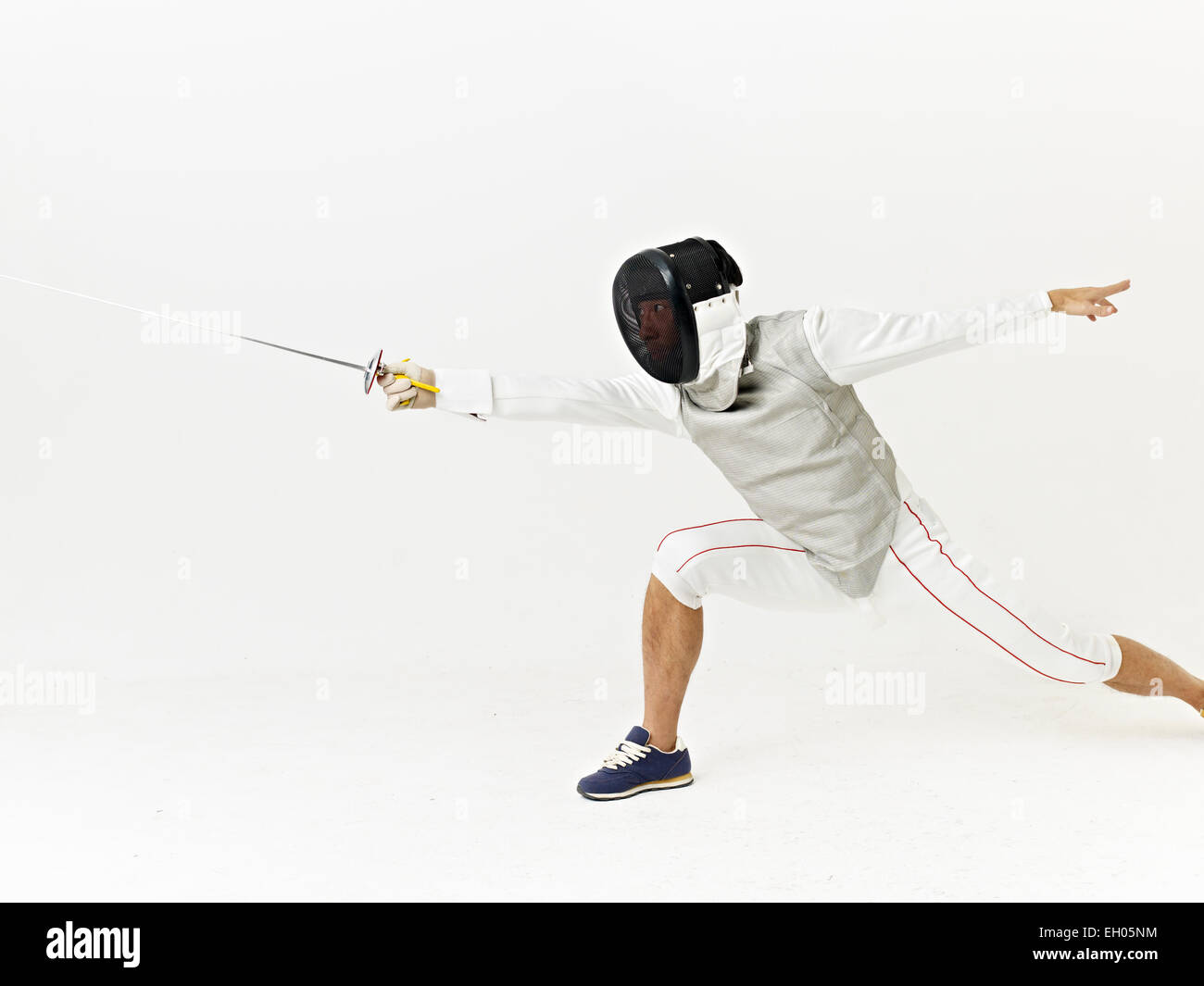 a male fencer attacking opponent. Stock Photo