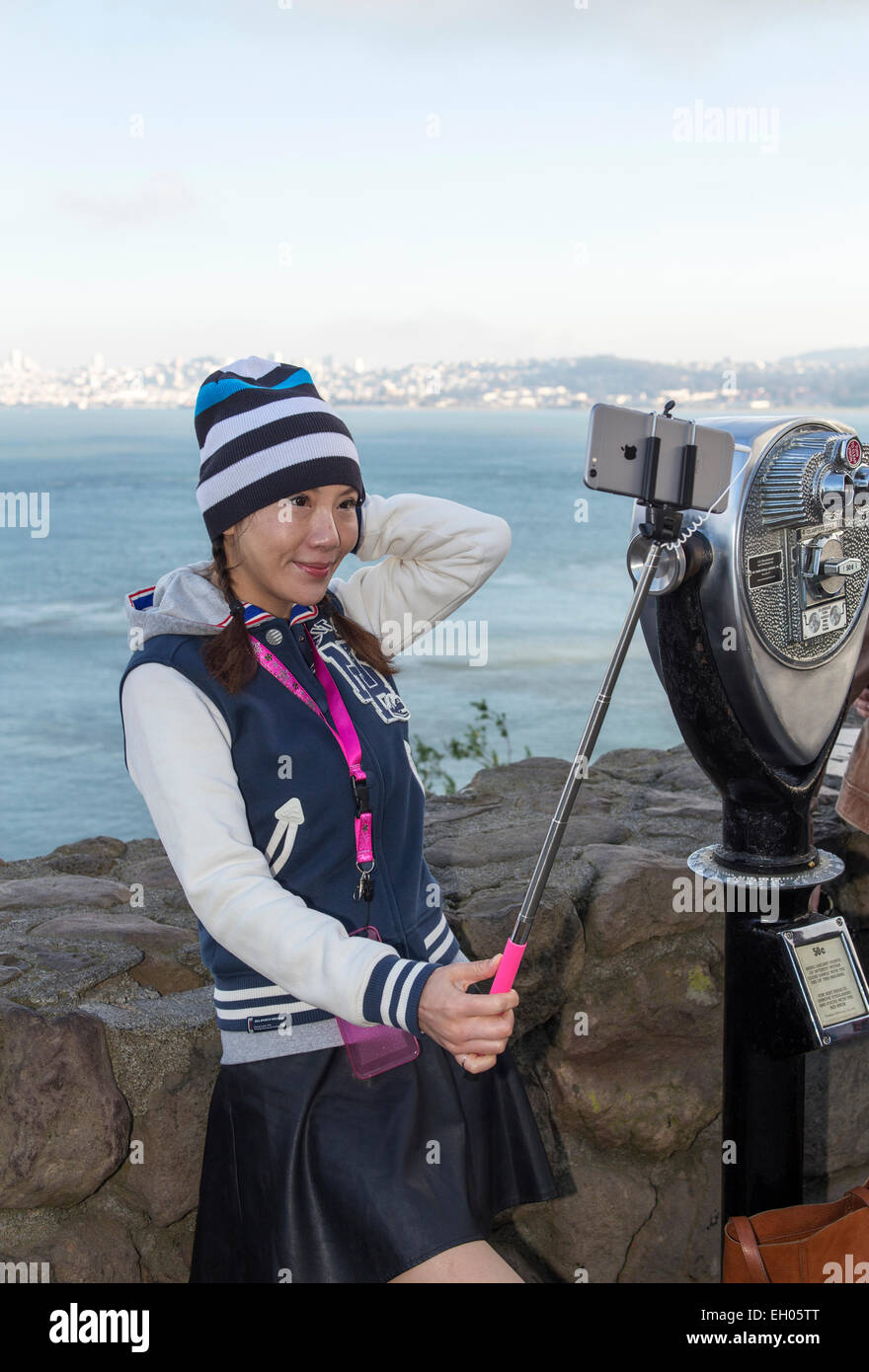 Asian woman, selfie stick, taking selfie, selfie photo, Vista Point, north side of Golden Gate Bridge, city of Sausalito, Sausalito, California Stock Photo