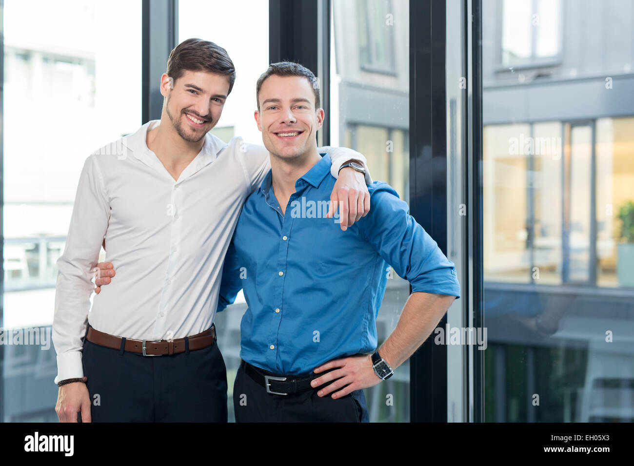 Two businessmen side by side in an office Stock Photo - Alamy
