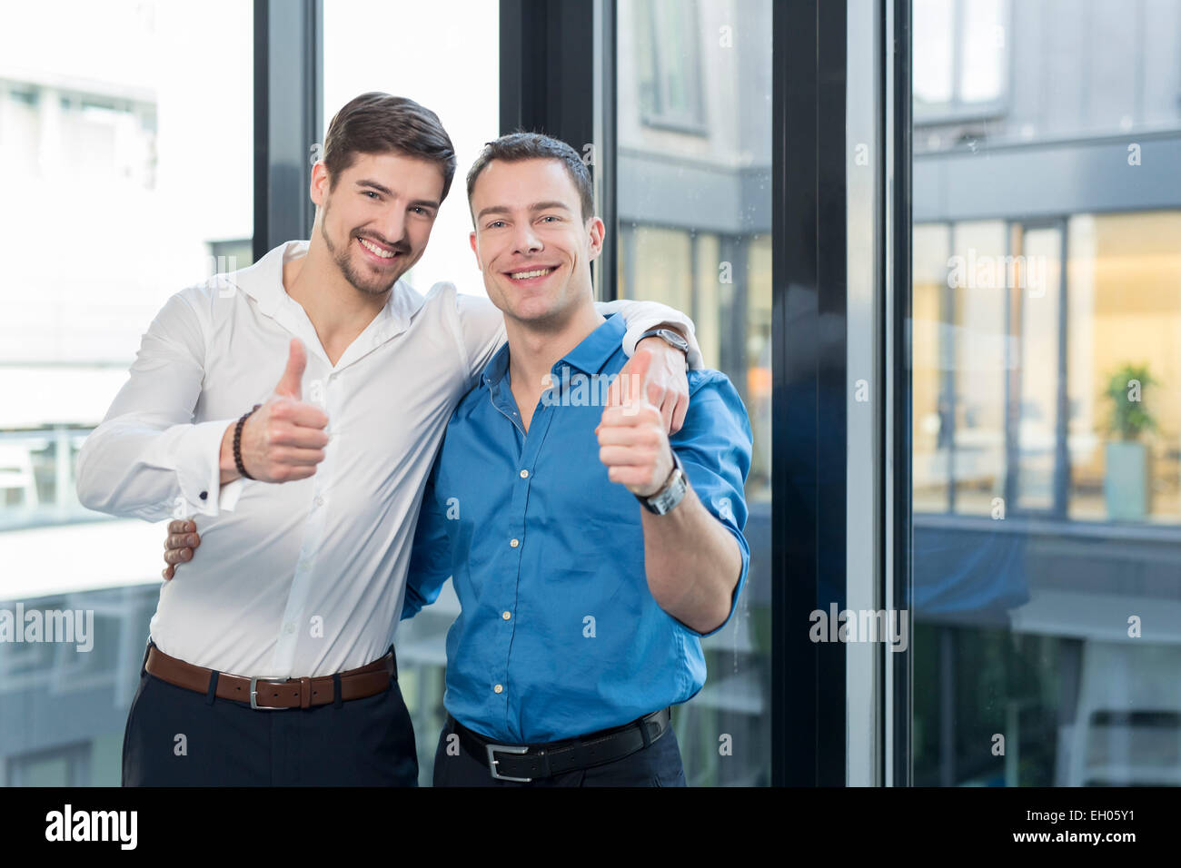 Two businessmen side by side in an office Stock Photo - Alamy